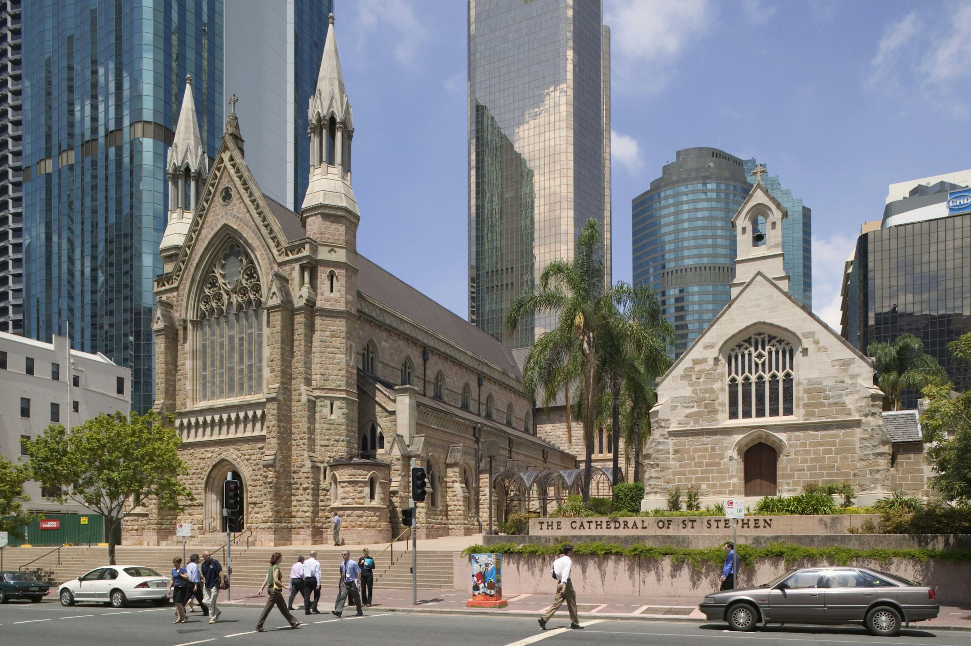 People walking past St Stephen's Cathedral in Brisbane