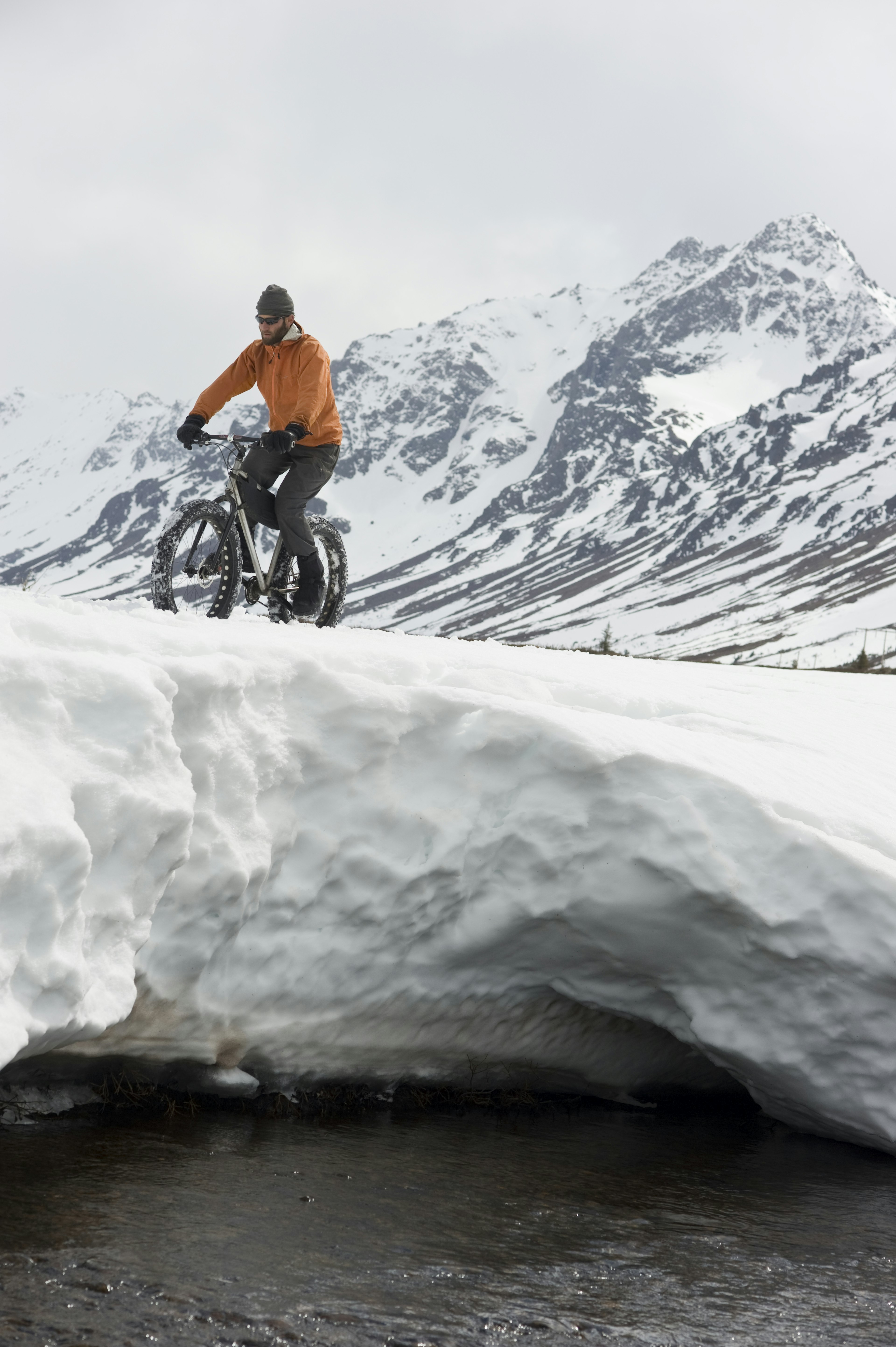 Man riding fat tire bike through the Chugach Mountains