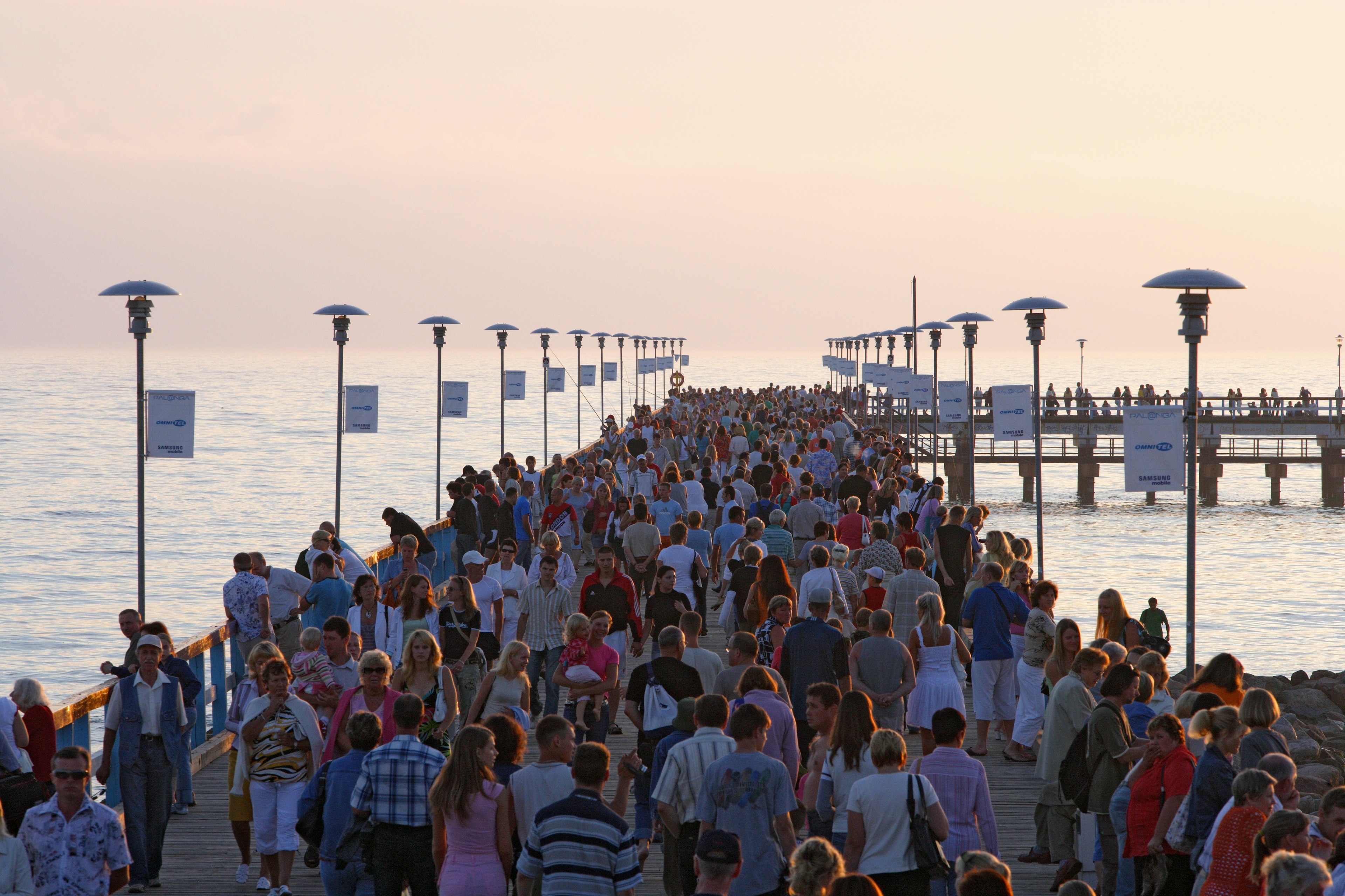 Throngs of people on a pier at sunset, Palanga, Lithuania