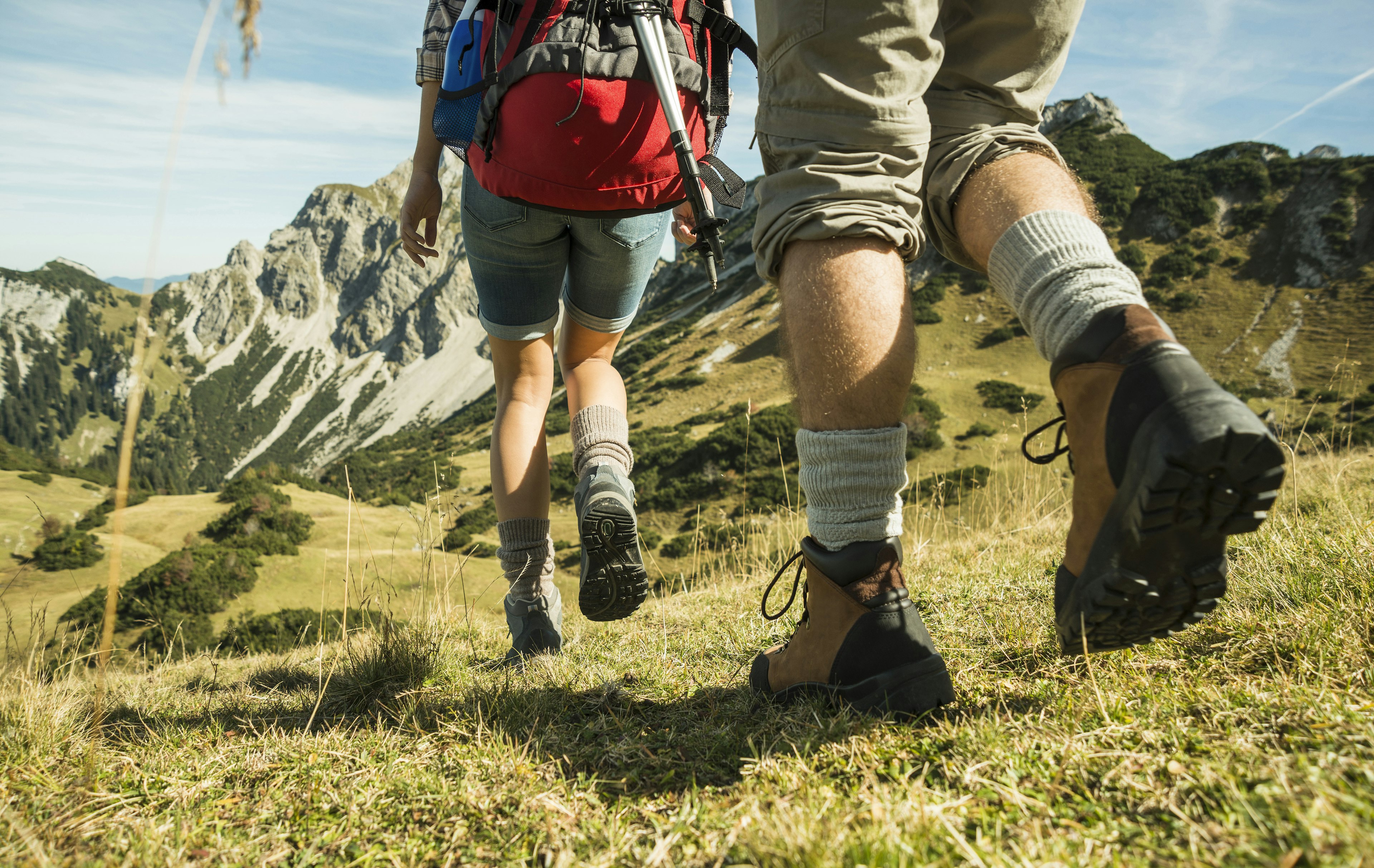 Hikers walking in Alpine meadows in Tyrol, Austria