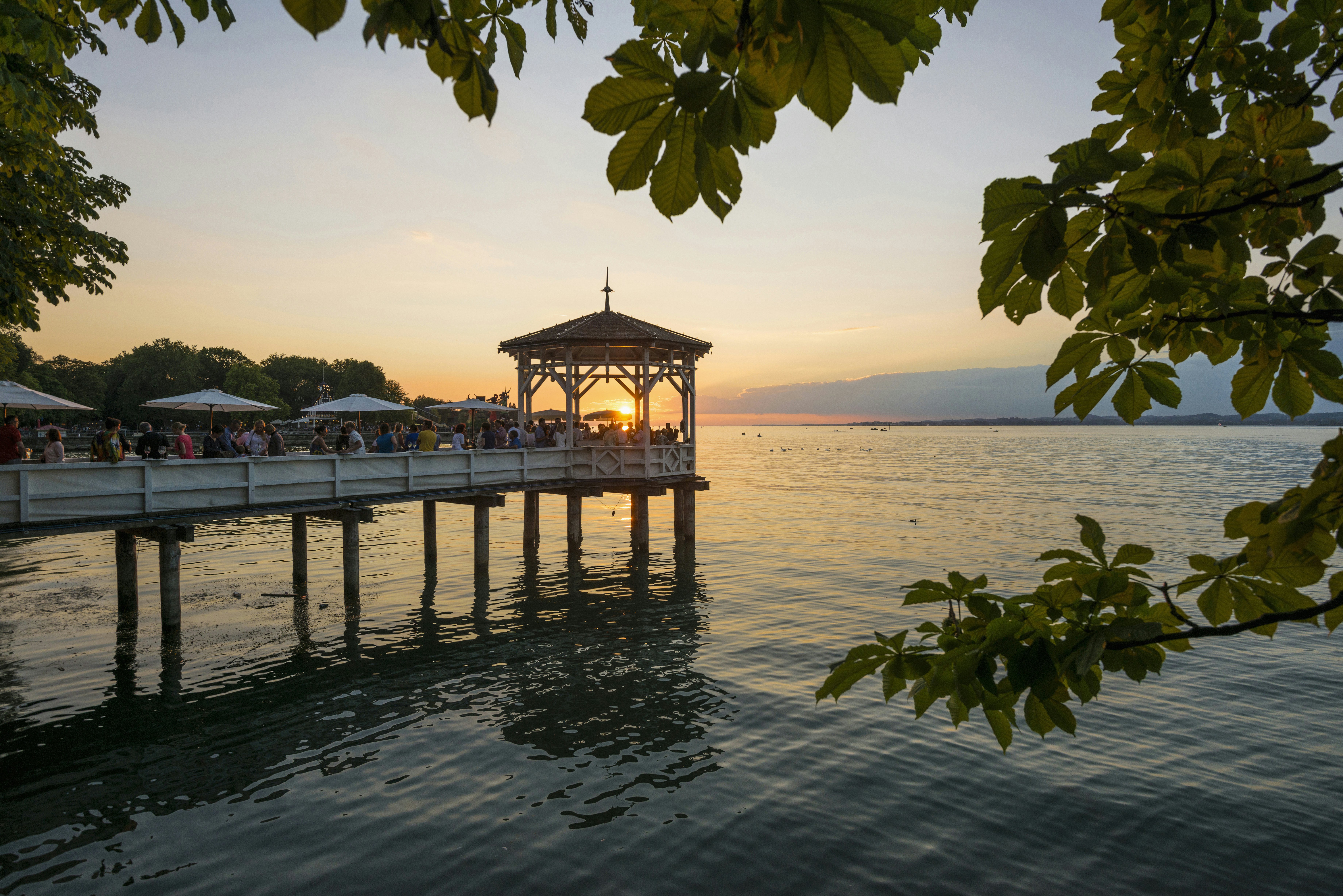 Pavilion with bar on the shore of Lake Constance at sunset.