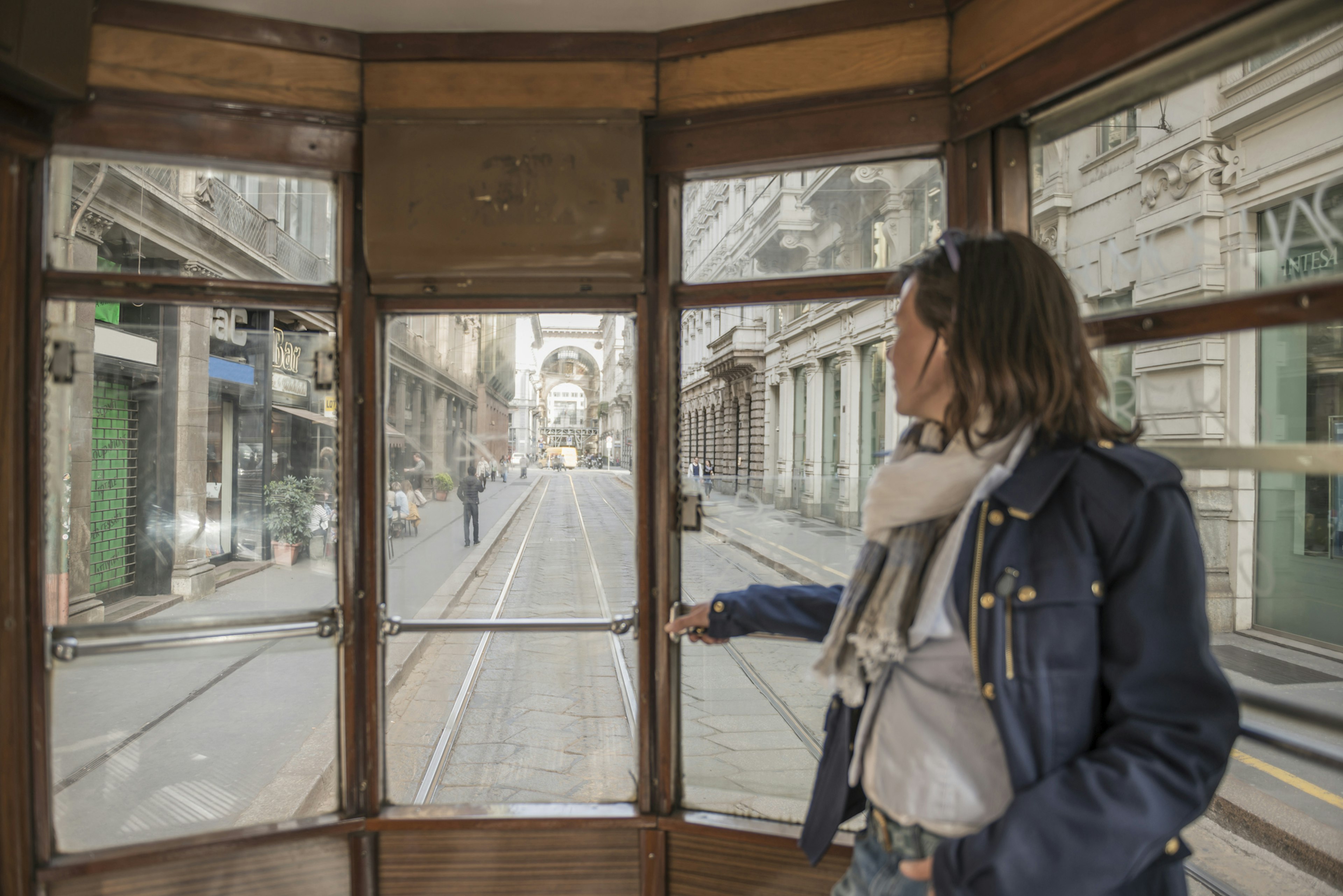 Woman traveling in an iconic tram in Milan, Italy