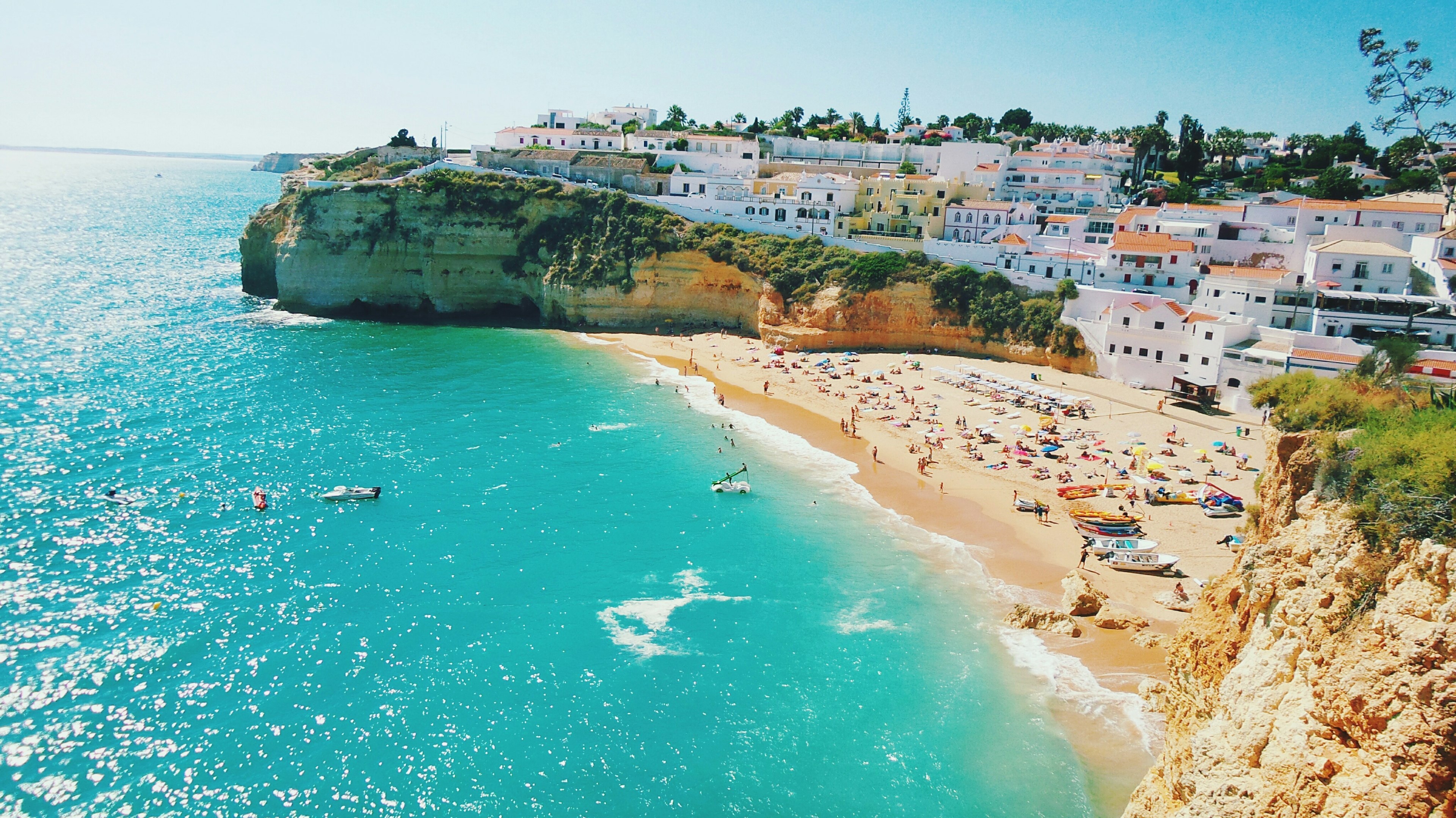 High angle view of beach and houses at Carvoeiro against clear sky