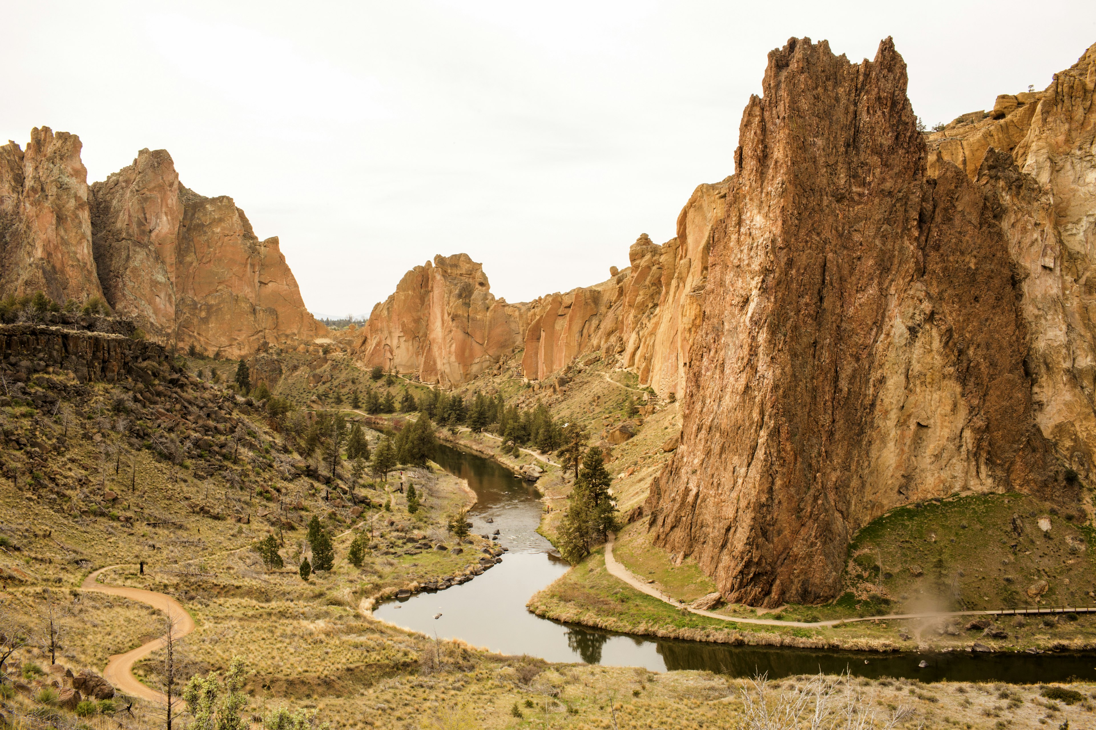 Stream through sheer cliffs in desert landscape, Smith Rock State Park, Oregon, United States