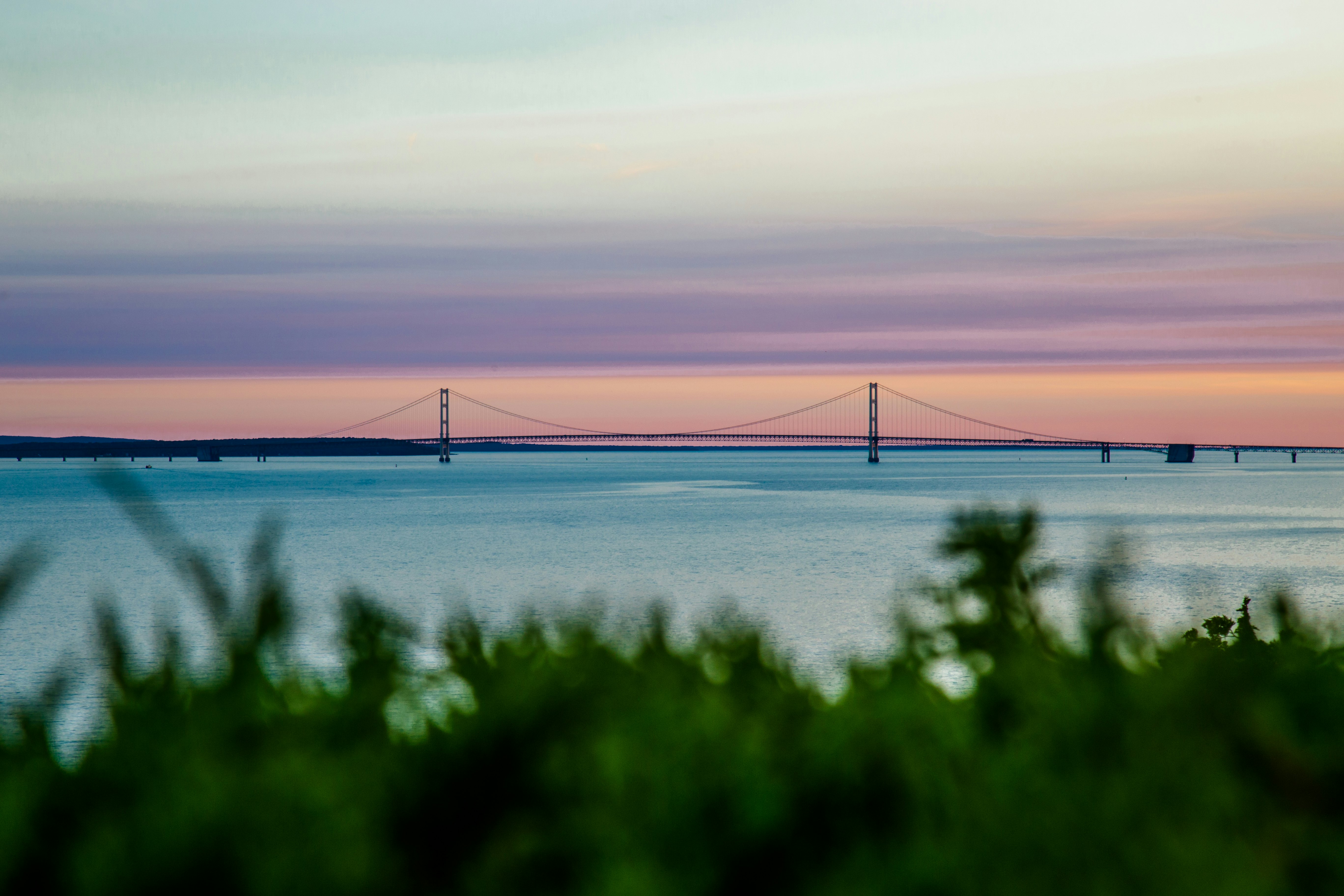 A colorful pink-hued sky over the huge Mackinac Bridge in Michigan