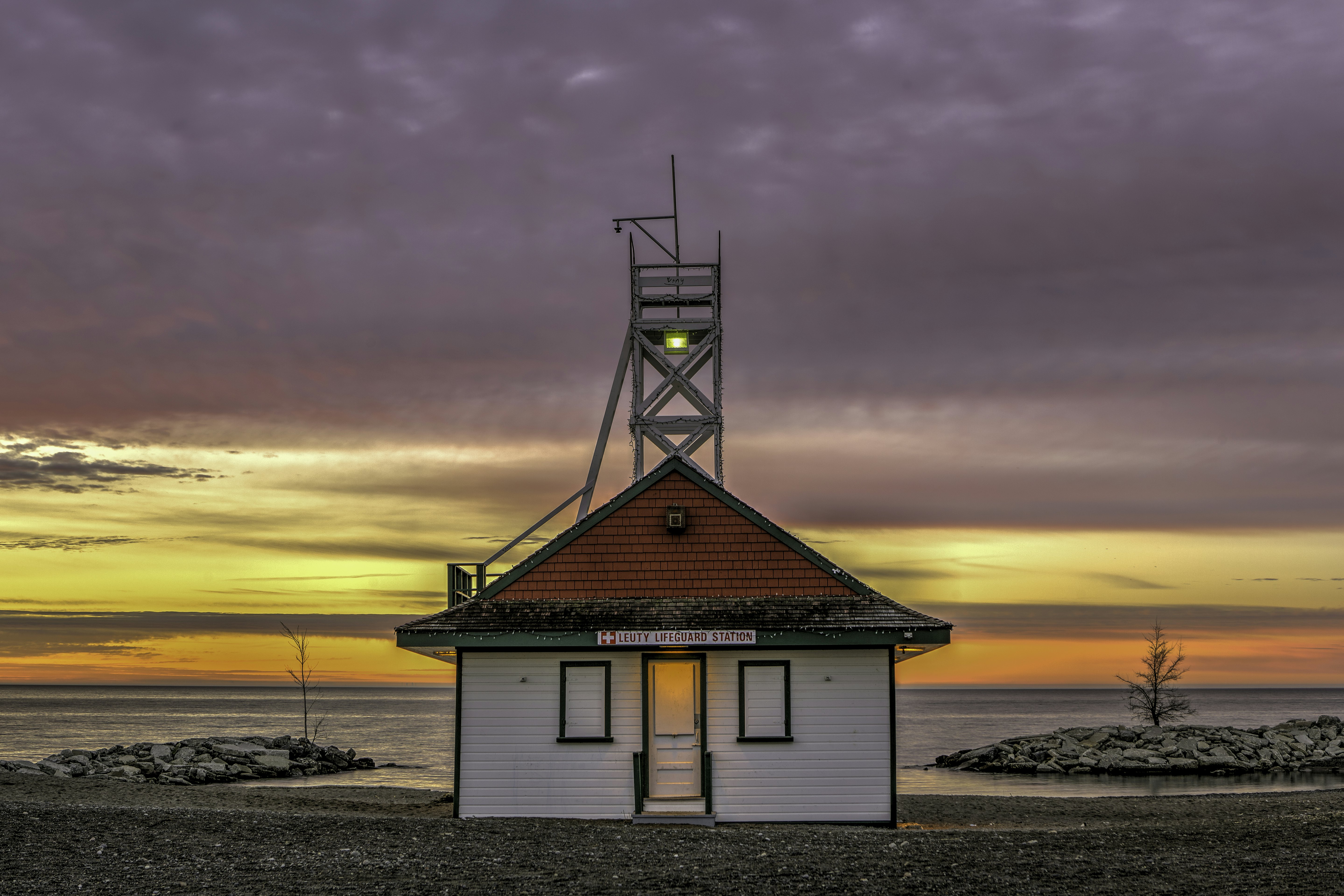 A lifeguard station with a sunrise inthe background