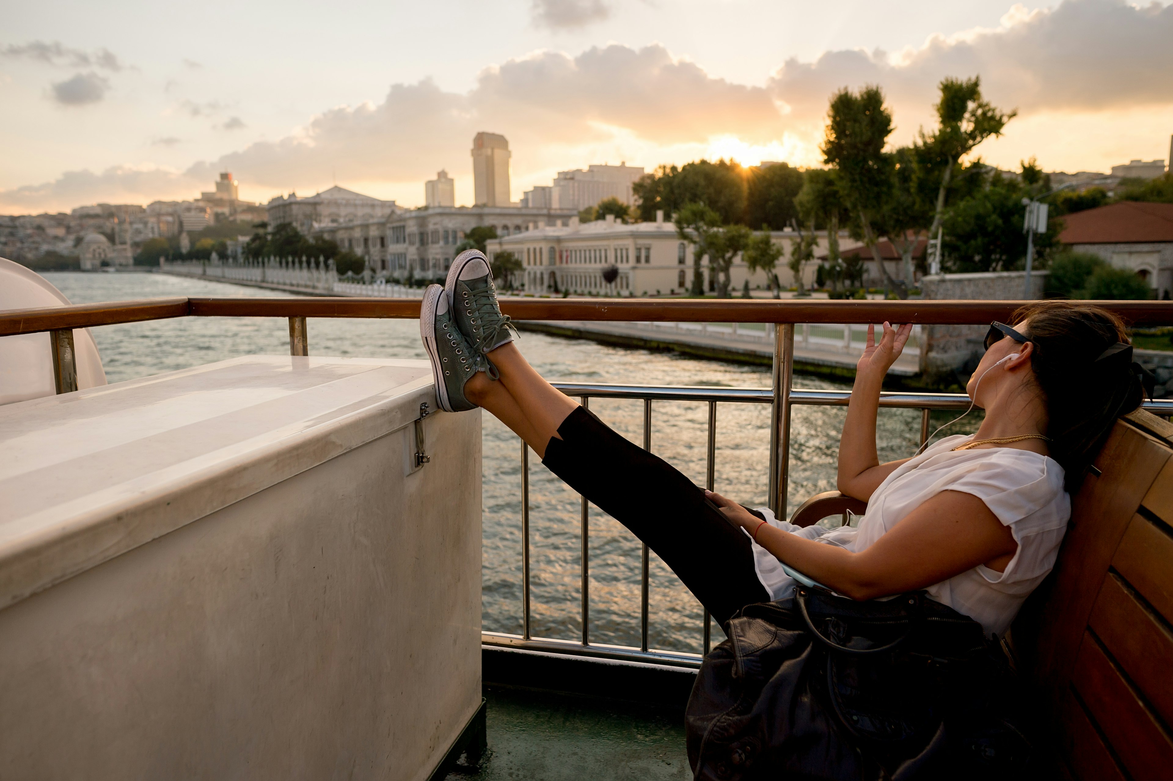 Woman sitting on an Istanbul ferry at sunset