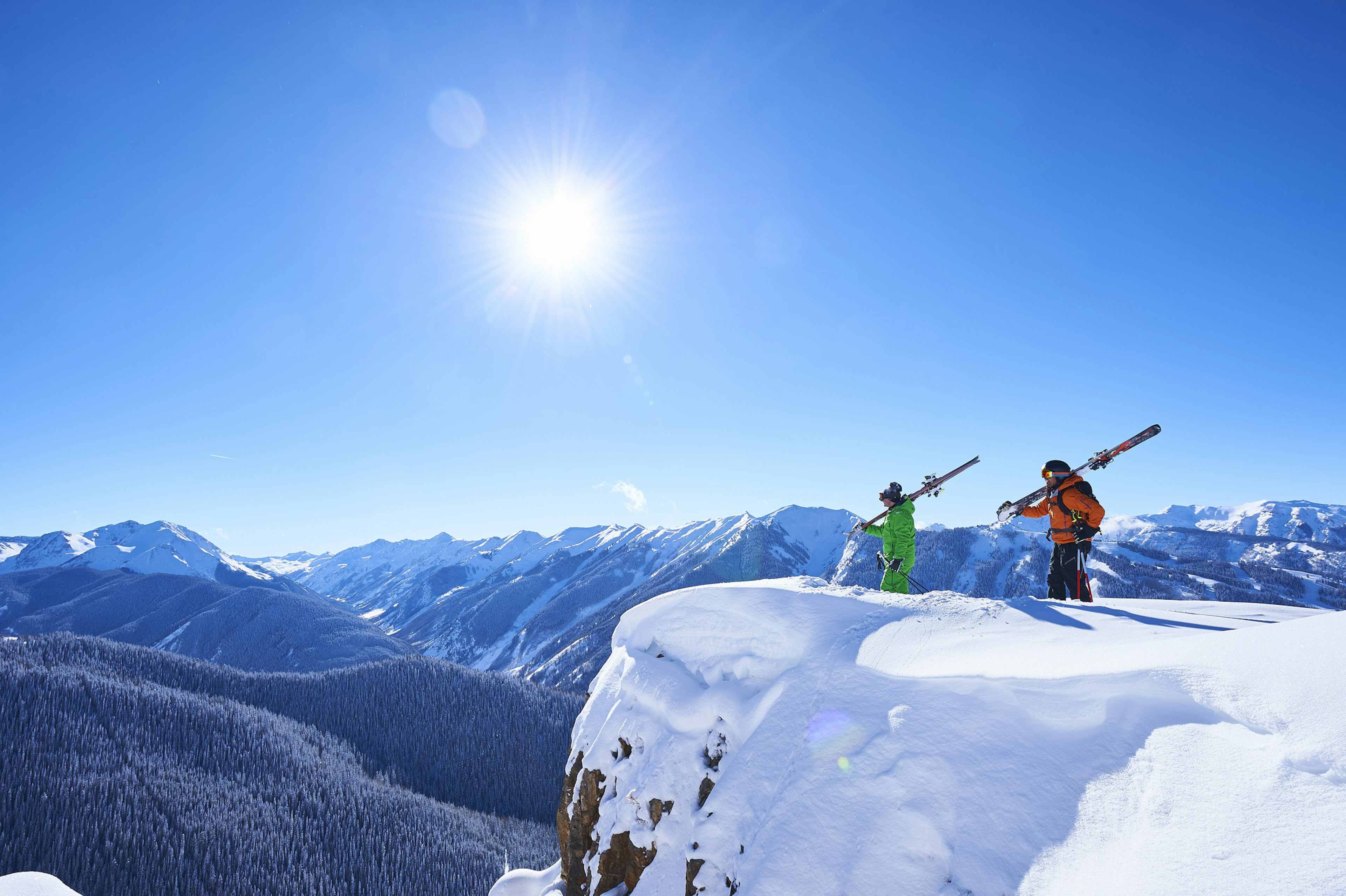 Two skiers take in the snowy views of Aspen, Colorado