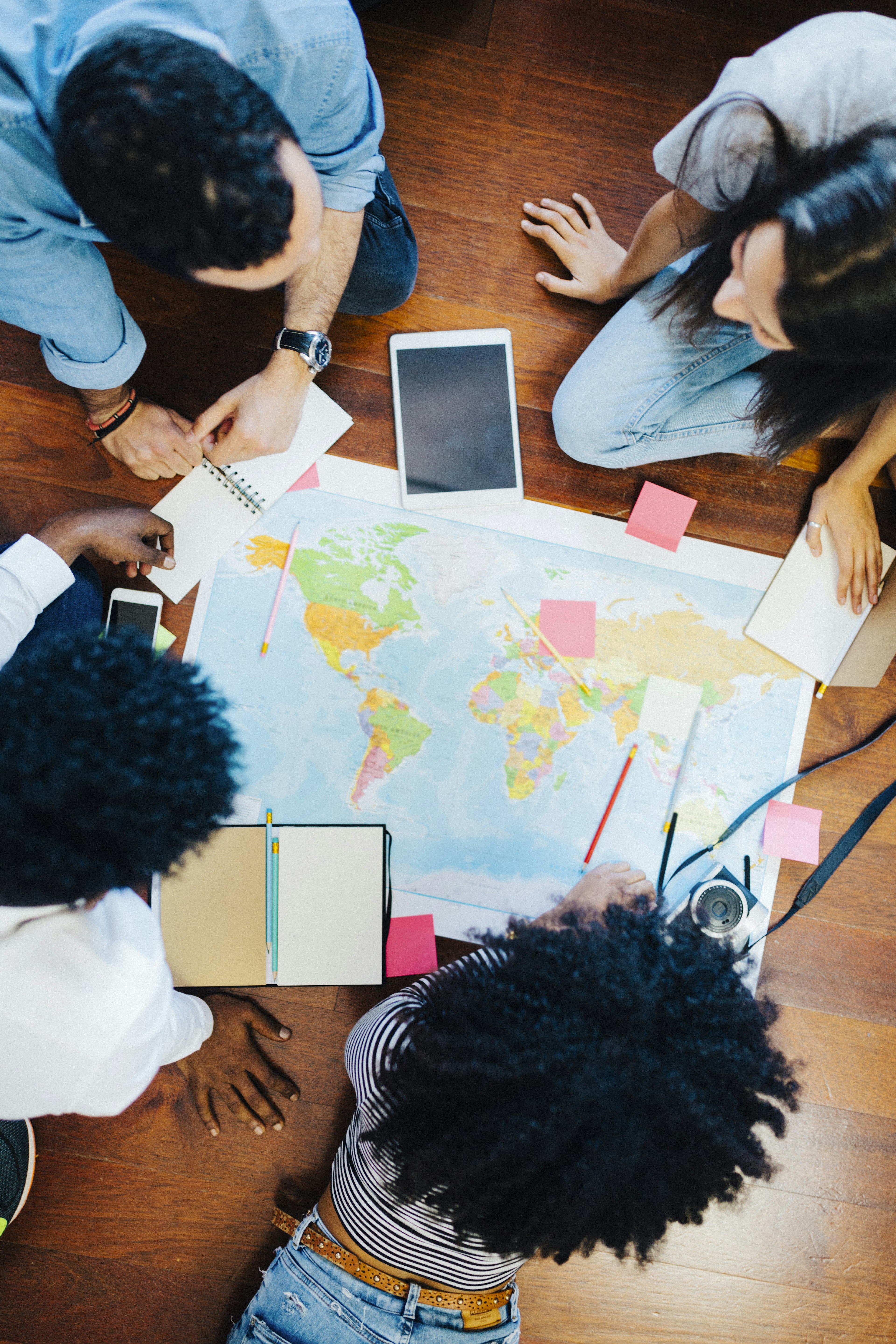 Group of friends looking at a world map