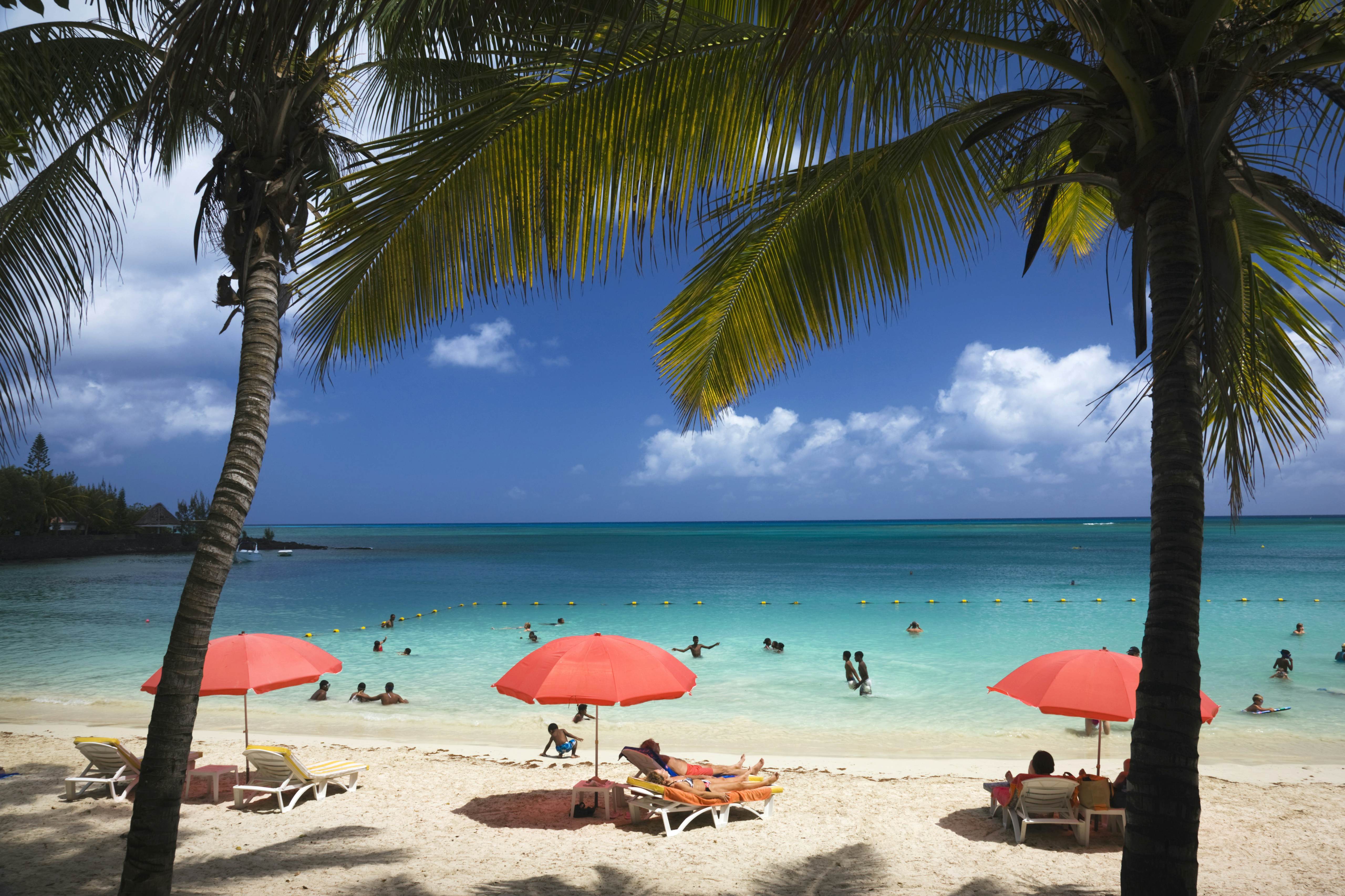 Sunbathers on a beach in northern Mauritius