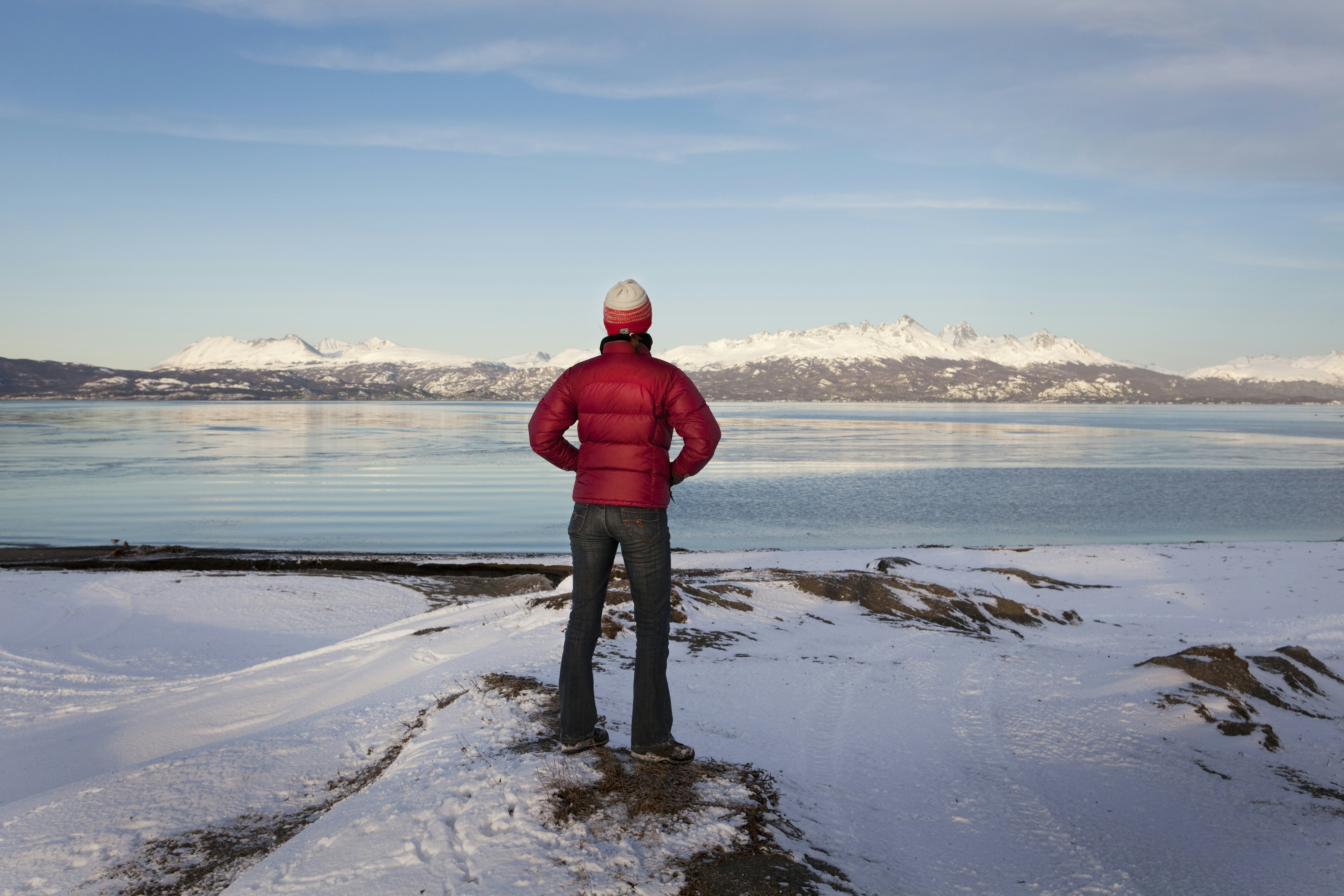 A hiker looks out at an empty landscape at Tierra del Fuego