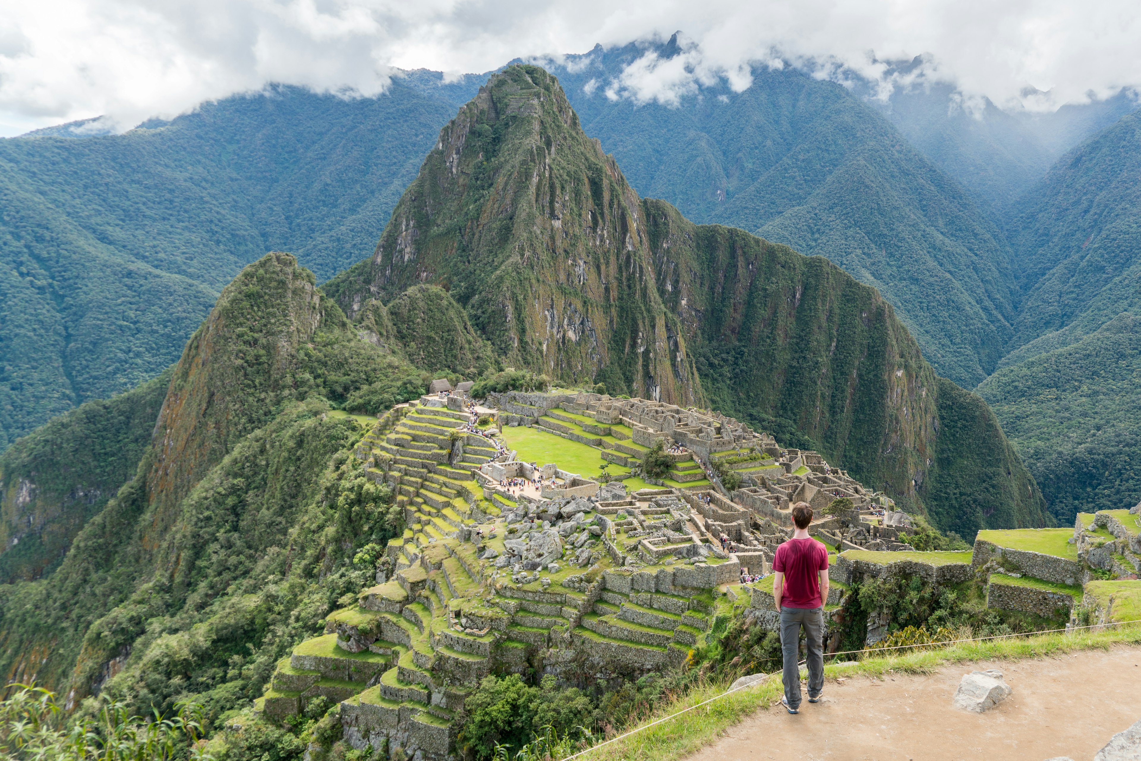 An aerial view of a hiker overlooking Machu Picchu