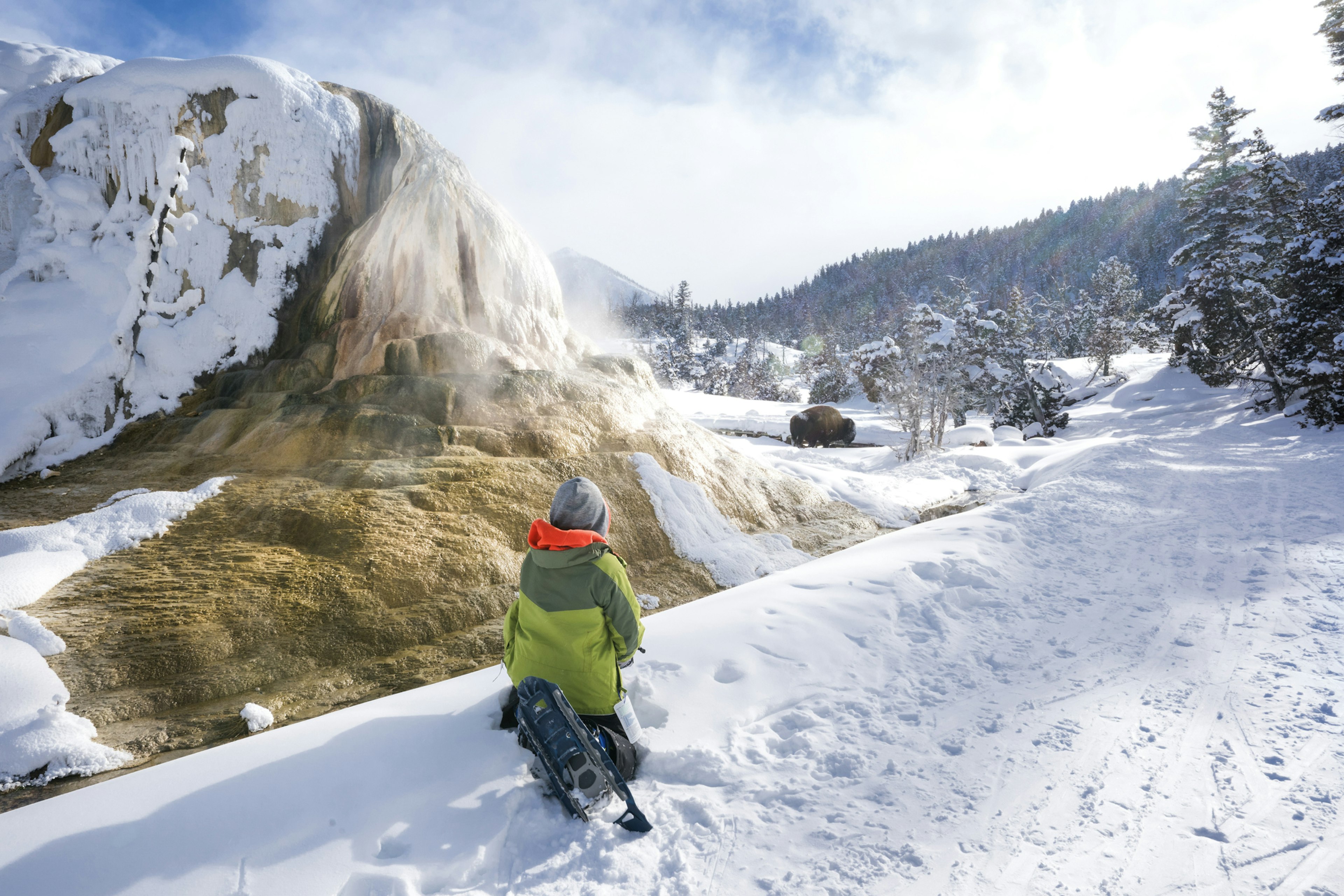 A boy looking over a snowy scene at Mammoth Hot Springs at Yellowstone National Park