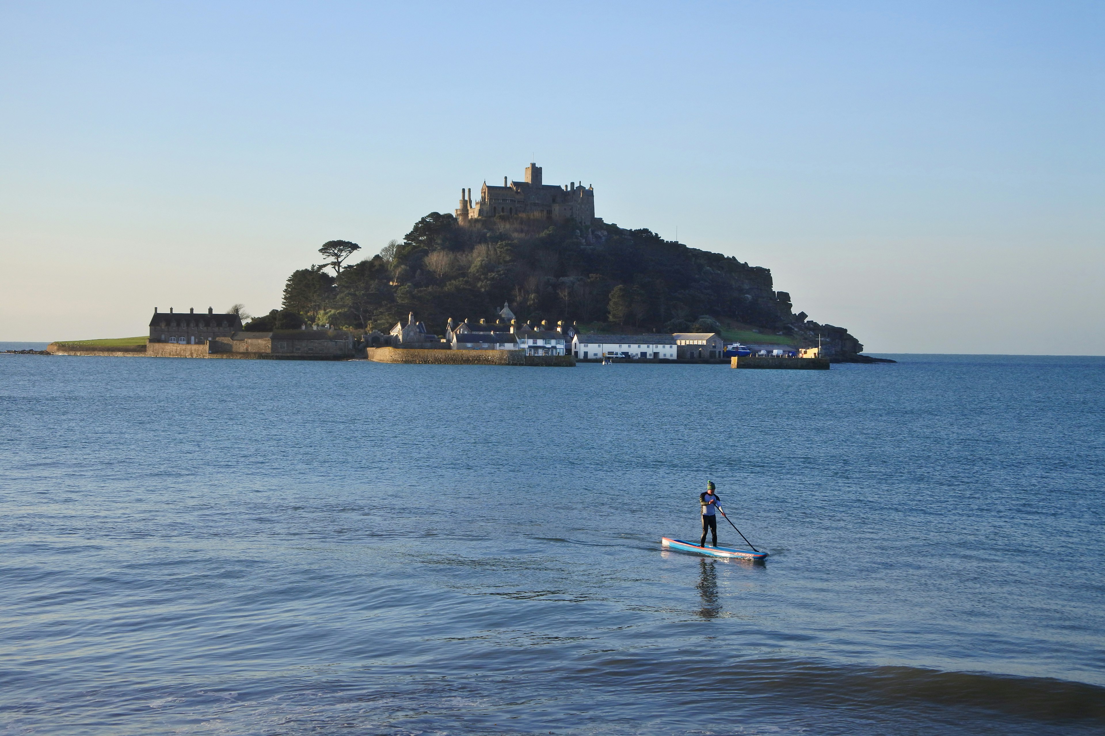 SUP paddleboarder in front of St. Michael's Mount, Cornwall