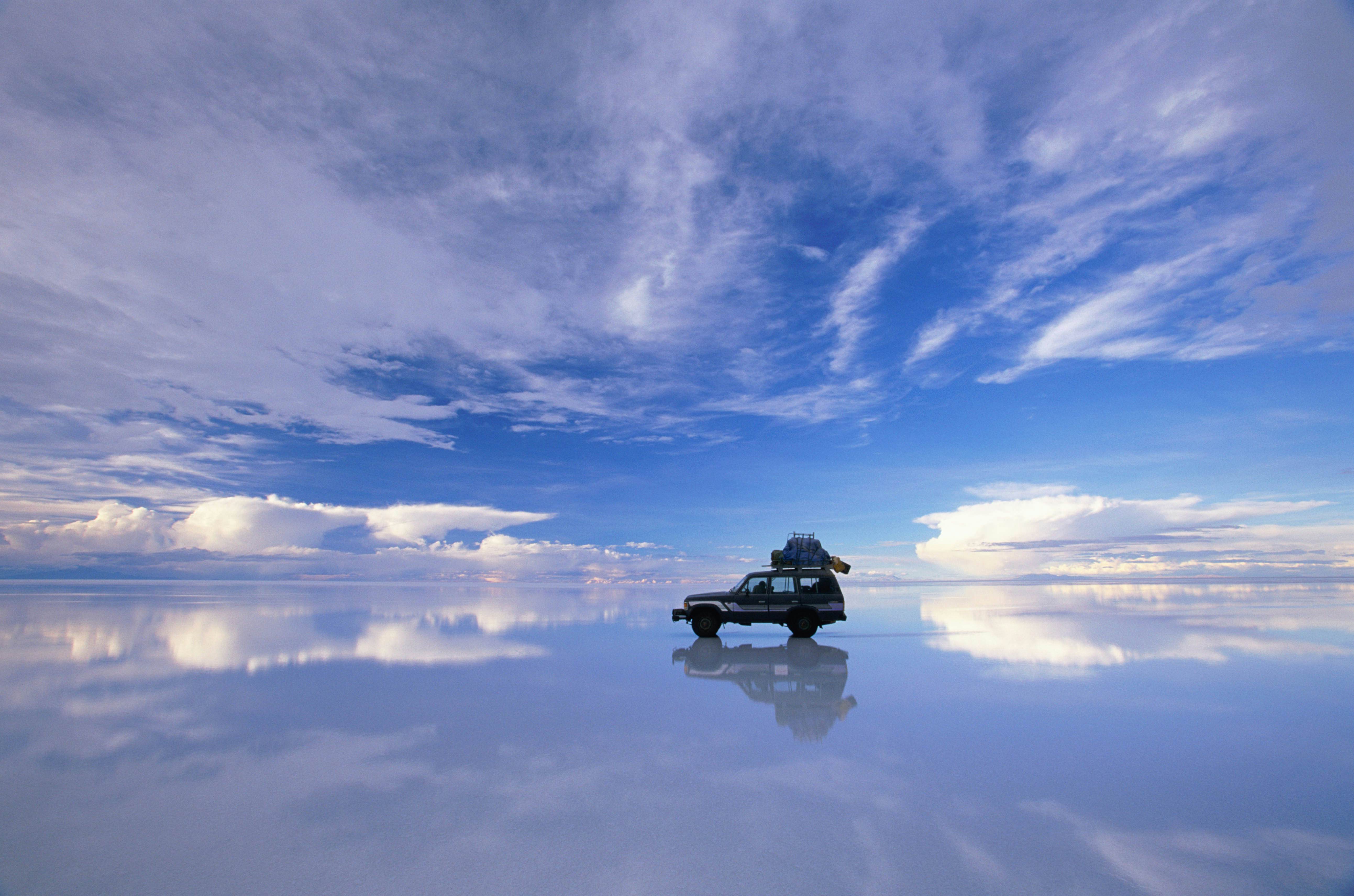 Four wheel drive on the reflective salt flats in Salar de Uyuni.