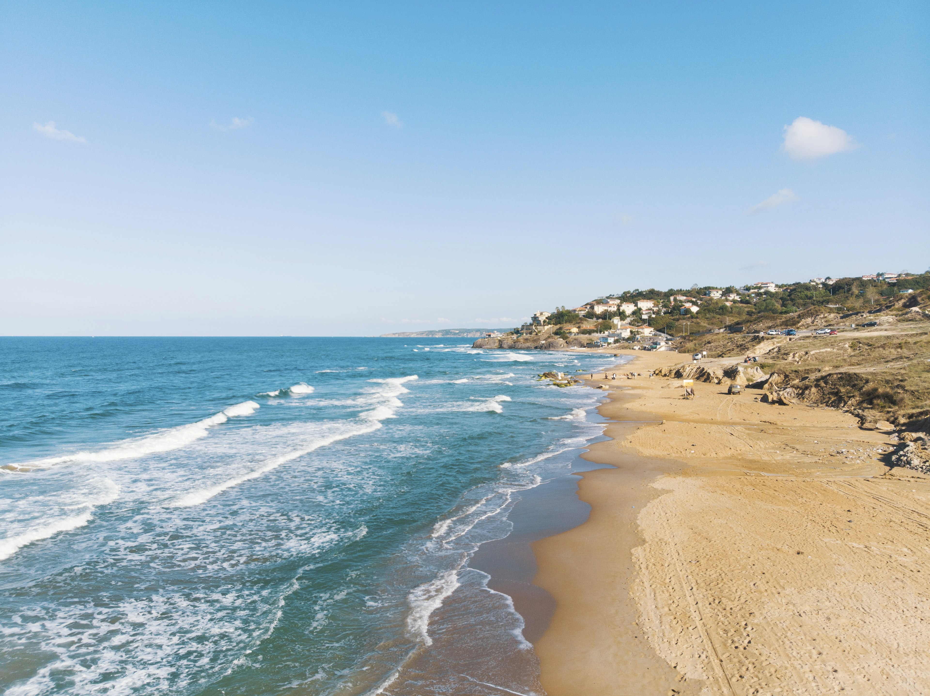 Sea waves lapping a sandy beach on a sunny day at Kilyos, near Istanbul