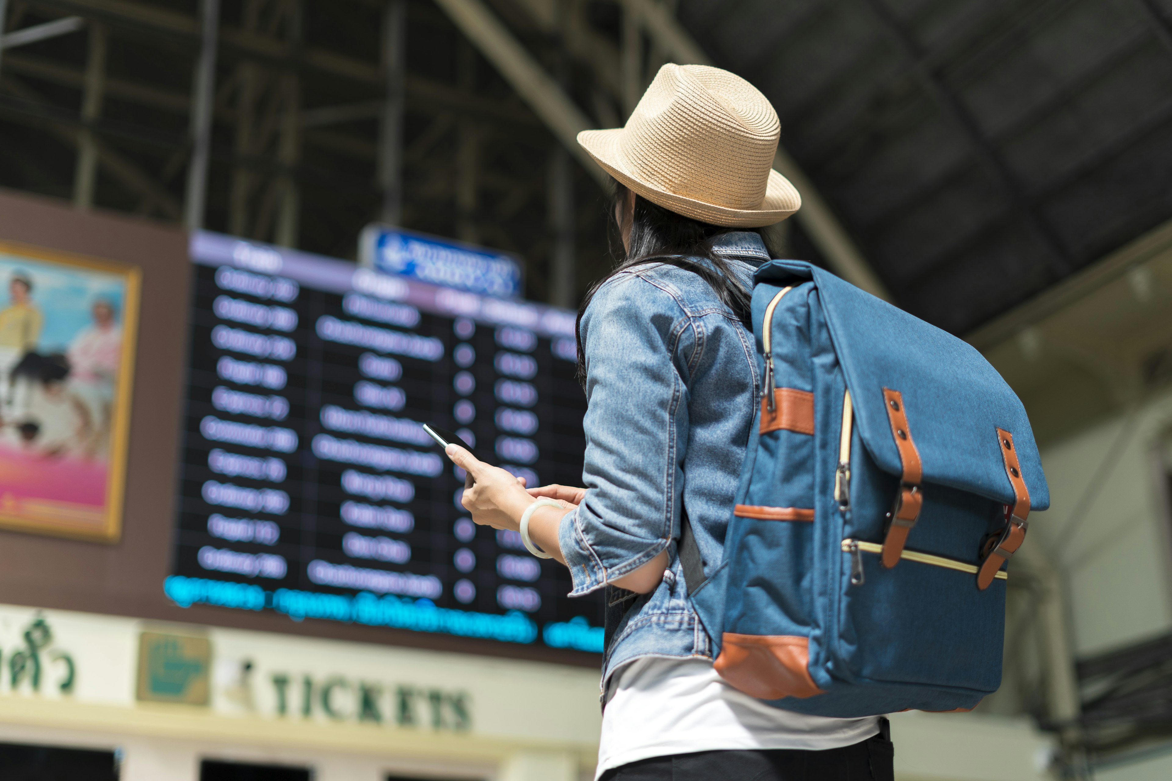 Young woman checking travel timetable board