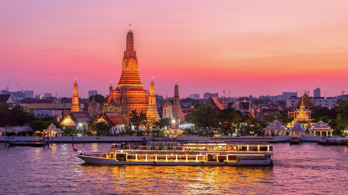 A ferry passes Wat Arun at twilight in Bangkok.
1057166794
Thailand, Cruise - Vacation, Temple - Building, Chao Phraya Rive, Chao Phraya River, Buddhism, East Asian Culture, Stupa, Night, Landscape - Scenery, Twilight, Community, Water, Vacations, Capital - Architectural Feature, Nature, Travel, Tourist, Dinner, Thai Culture, Business Travel, Landscaped, River, Urban Skyline, Waterfront, Wat Arun, Backgrounds, Scenics - Nature, City, Cityscape, Architecture, Sunset, Famous Place, International Landmark, No People, Cruise Ship, Photography, Travel Destinations, Horizontal, History, Spirituality, Bangkok, Local Landmark, Wat, Dusk, Passenger Craft, Asia, Bangkok Province, Cultures, Journey, Religion, Arranging, Outdoors, Pagoda