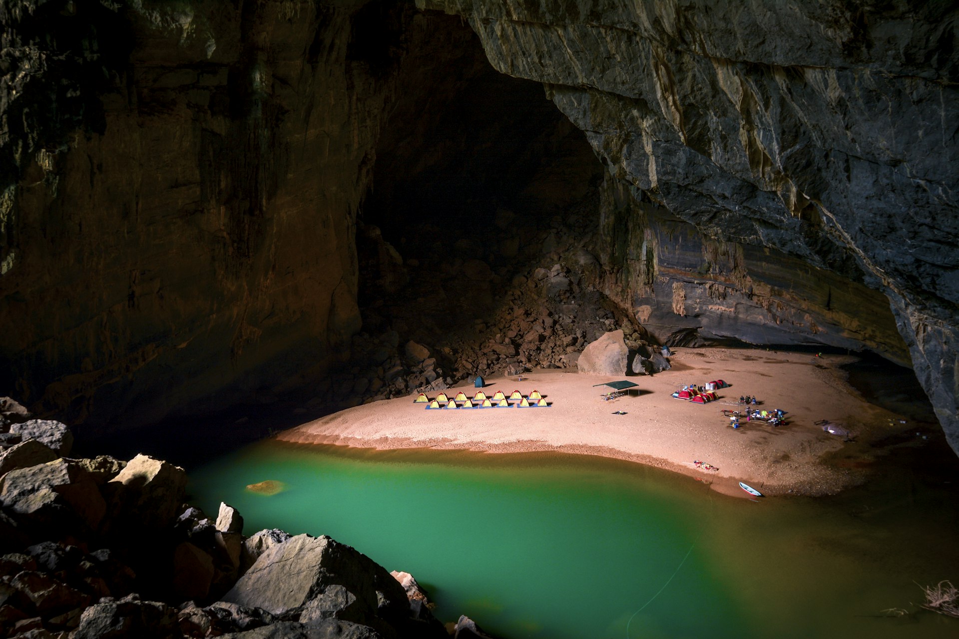 Campsite on the beach and a small lake inside the Hang En Cave. 