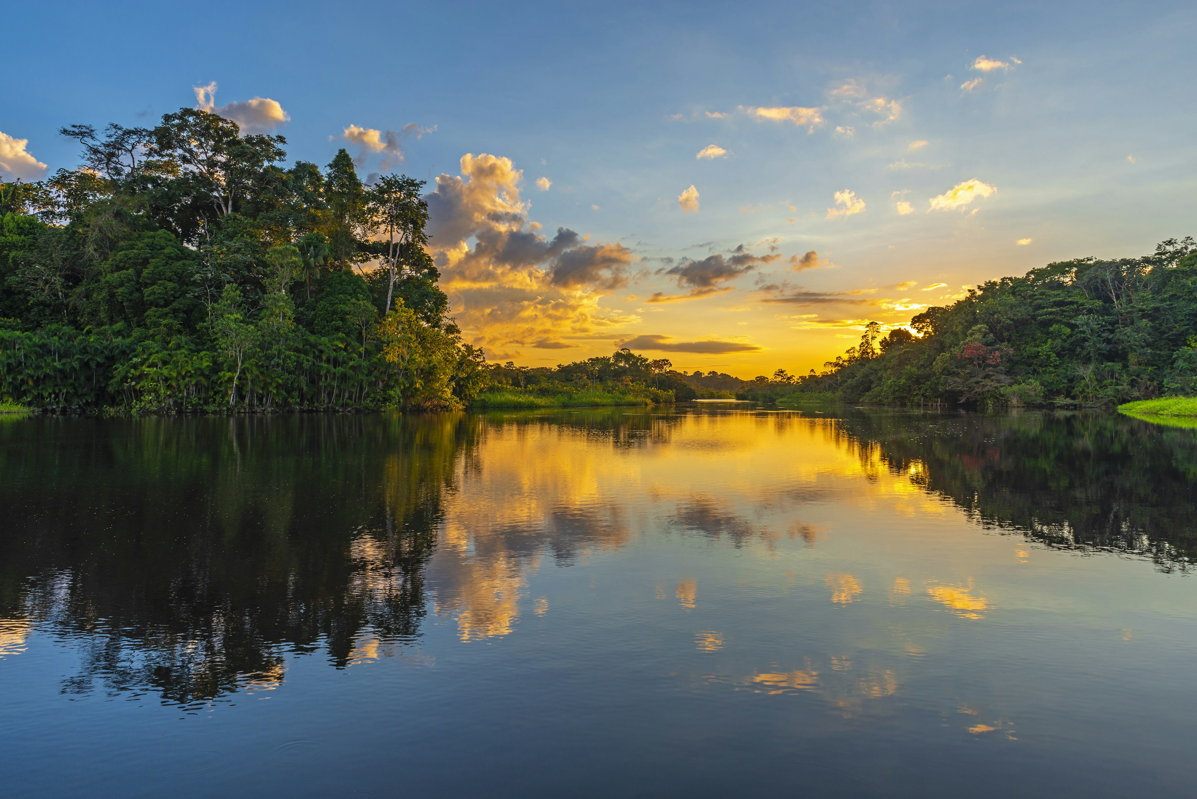 Reflection of a sunset by a lagoon in the Amazon