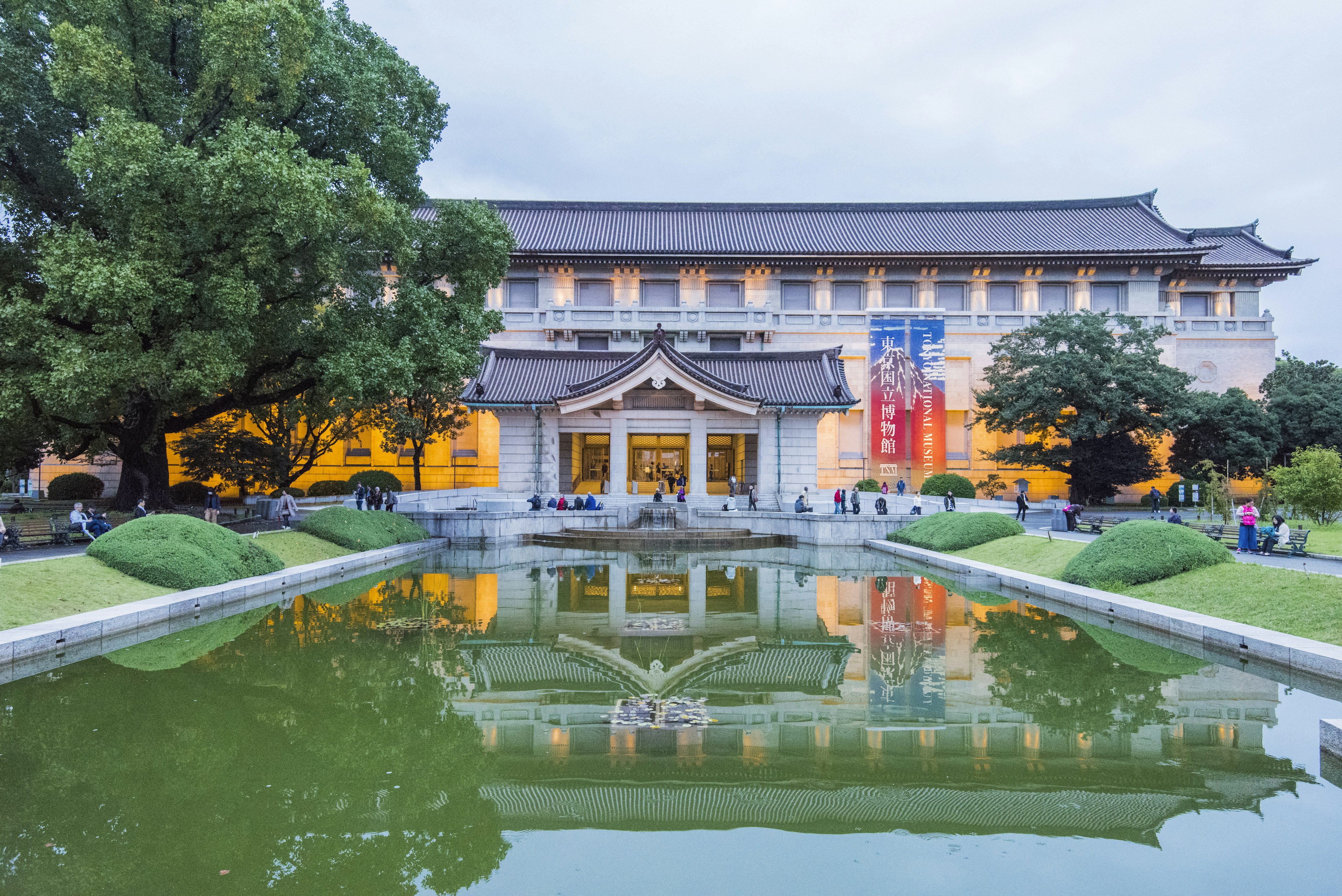 People walking at dusk near the entrance of the Honkan (Japanese Gallery) in the Tokyo National Museum