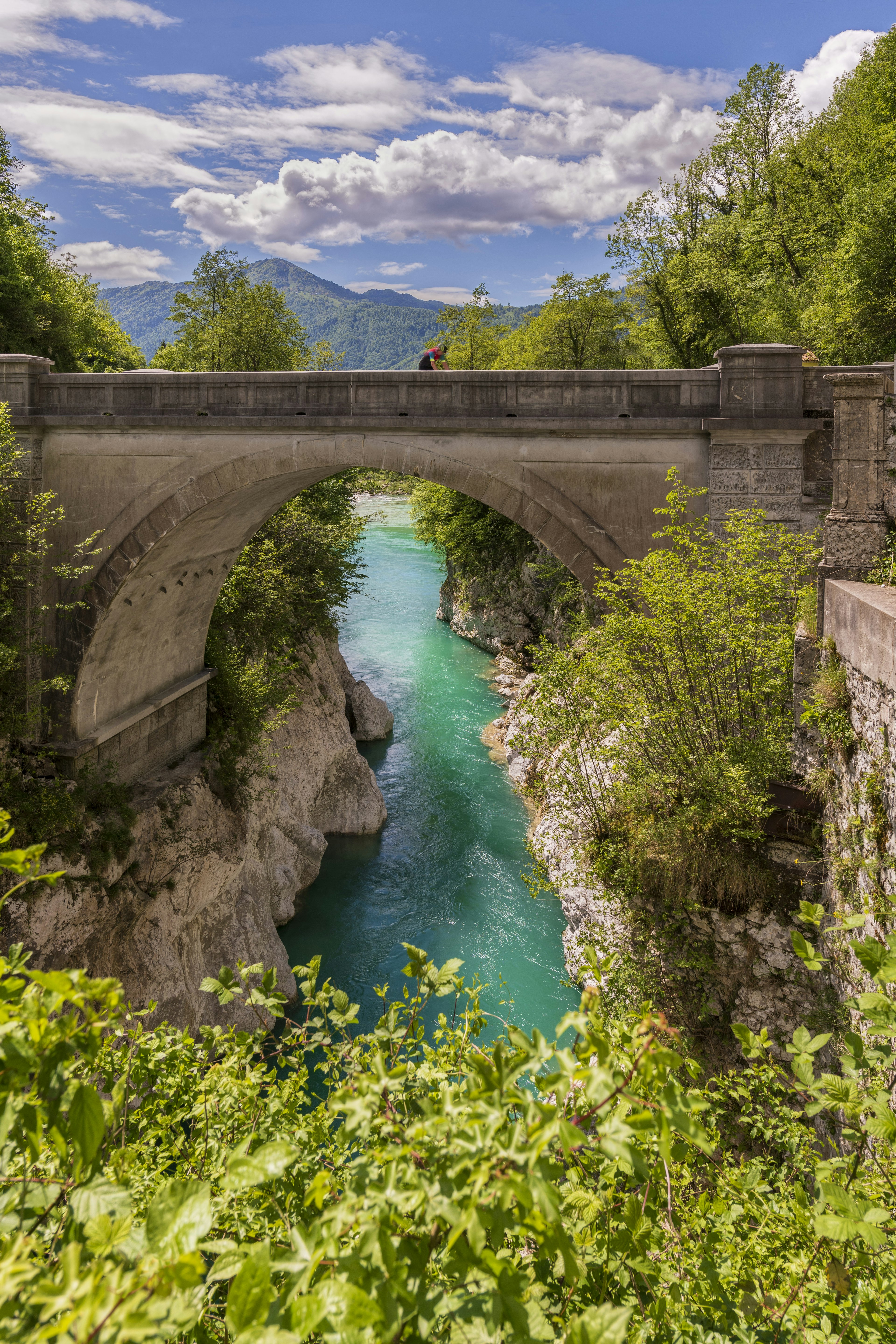 A cyclist crosses Napoleon's Bridge over the Soča River, Slovenia