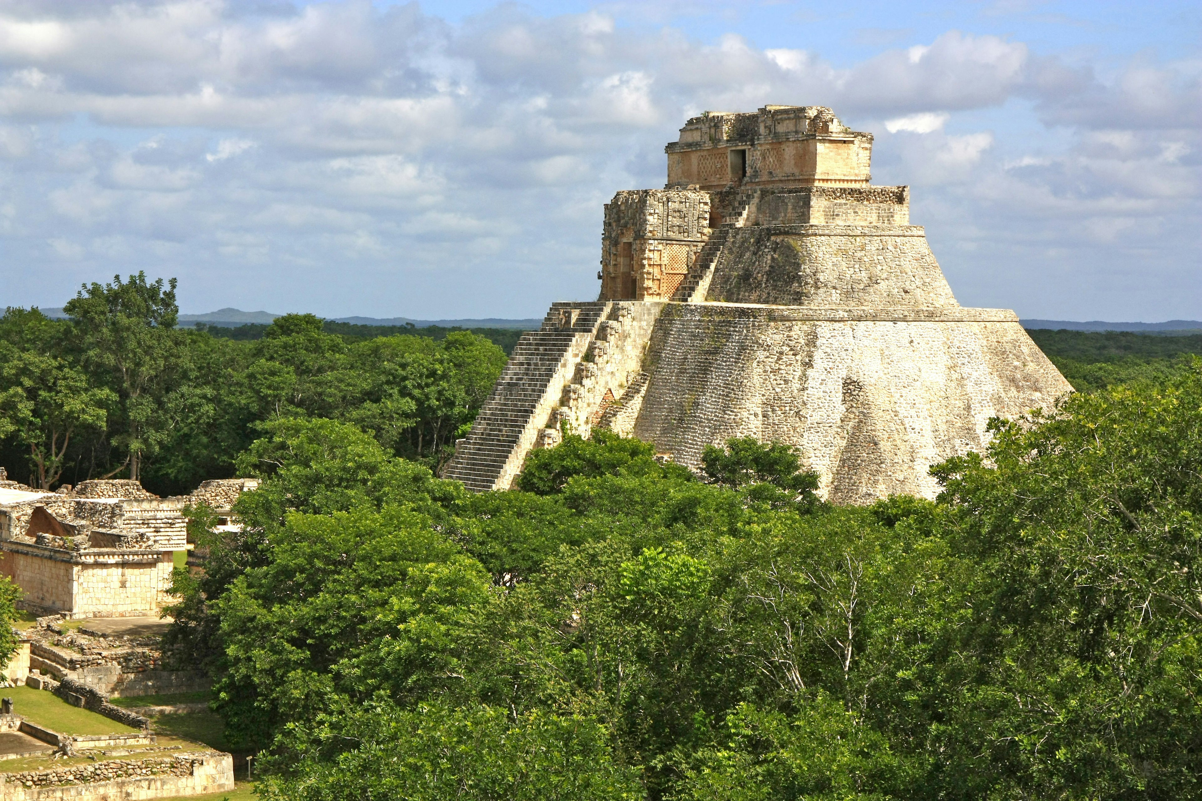 Pyramid of Magician rising through the jungle at Uxmal, Mexico