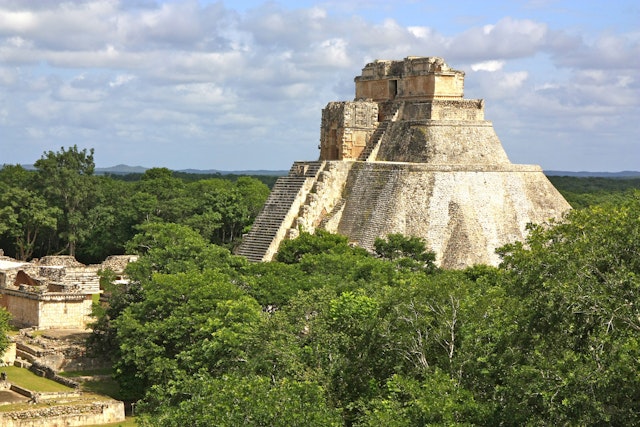 Pyramid of Magician rising through the jungle at Uxmal, Mexico