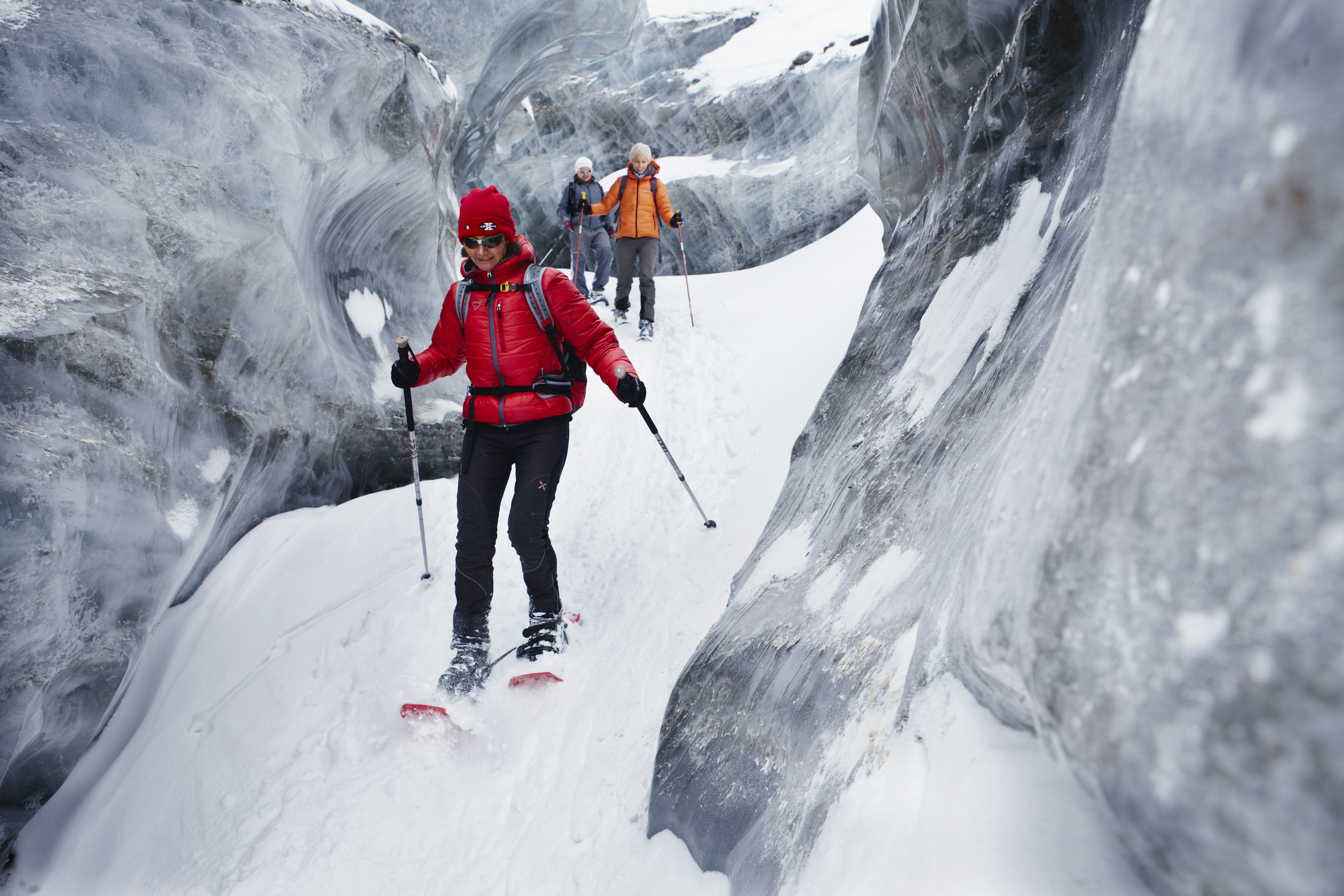 Group of people with snowshoes exploring glacier