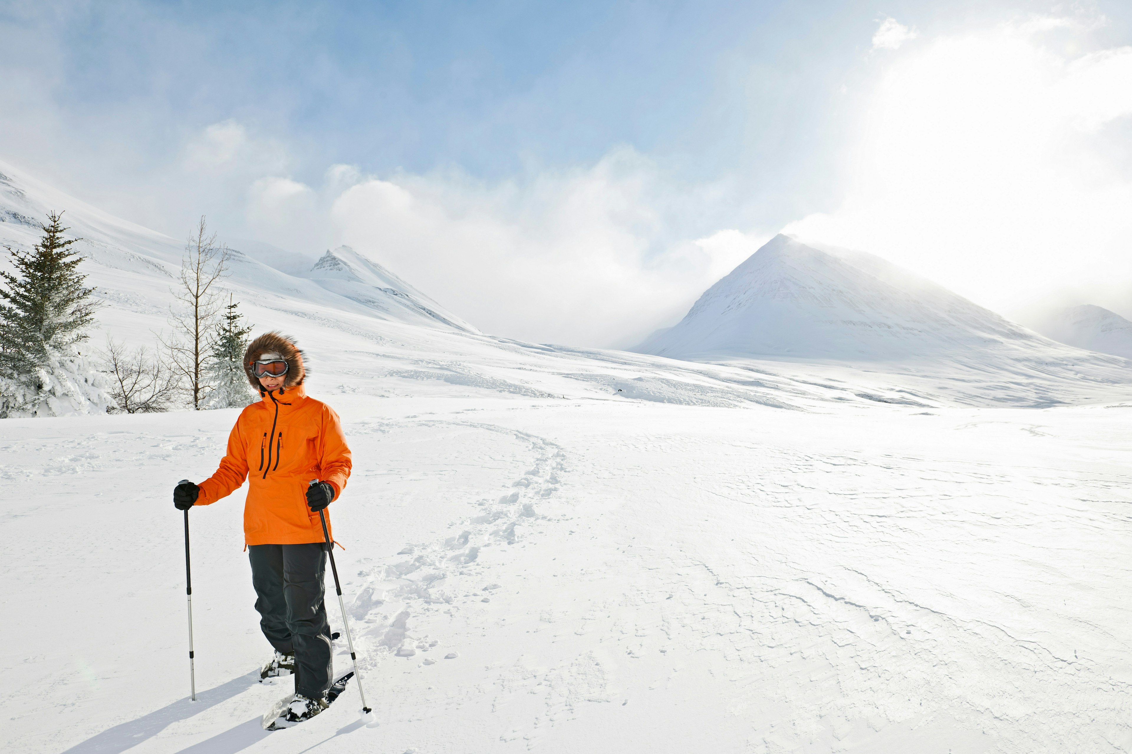 Woman walking on snow shoes in Skidadalur, Dalvik, Iceland