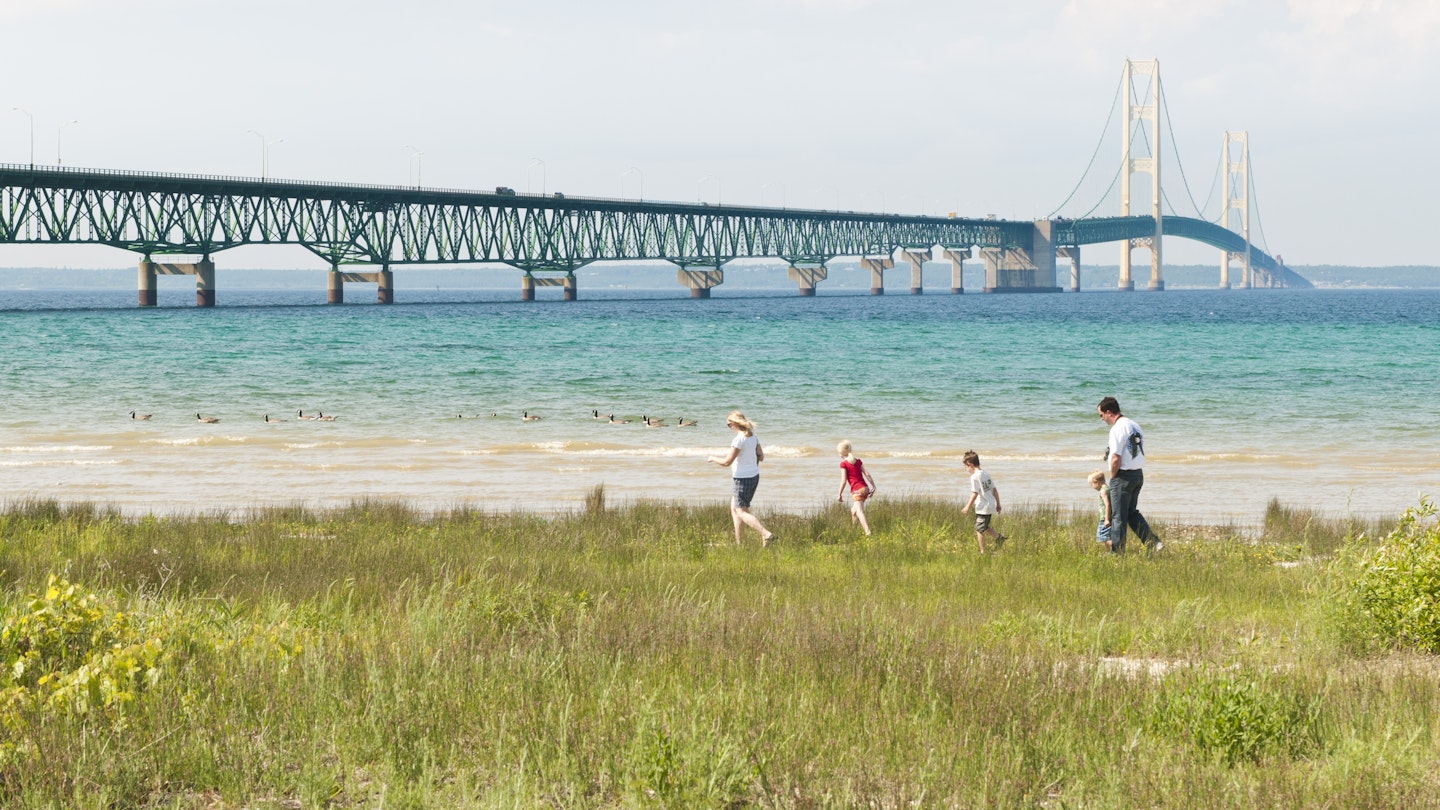 June 17, 2011: A family walks on the shore near Mackinac Bridge (also known as the Mighty Mac), which crosses the Straits of Mackinac.
458678009
Outdoors, Nature, USA, Architecture And Buildings, Water's Edge, Midwest USA, Color Image, Travel Destinations, Horizontal, Mackinaw City, Michigan, Lake Michigan, Sky, Lake, Beach, Travel, Tower, Mackinac Bridge, Upper Peninsula, Editorial, Suspension Bridge, Landscape, Family, Scenics - Nature, Straits of Mackinaw, Mighty Mac, Bridge - Built Structure, Summer, Bridge, Built Structure, Lake Huron, Tourist, Vacations, Water, North America, Lakeshore, Great Lakes, Mackinac Island, Photography