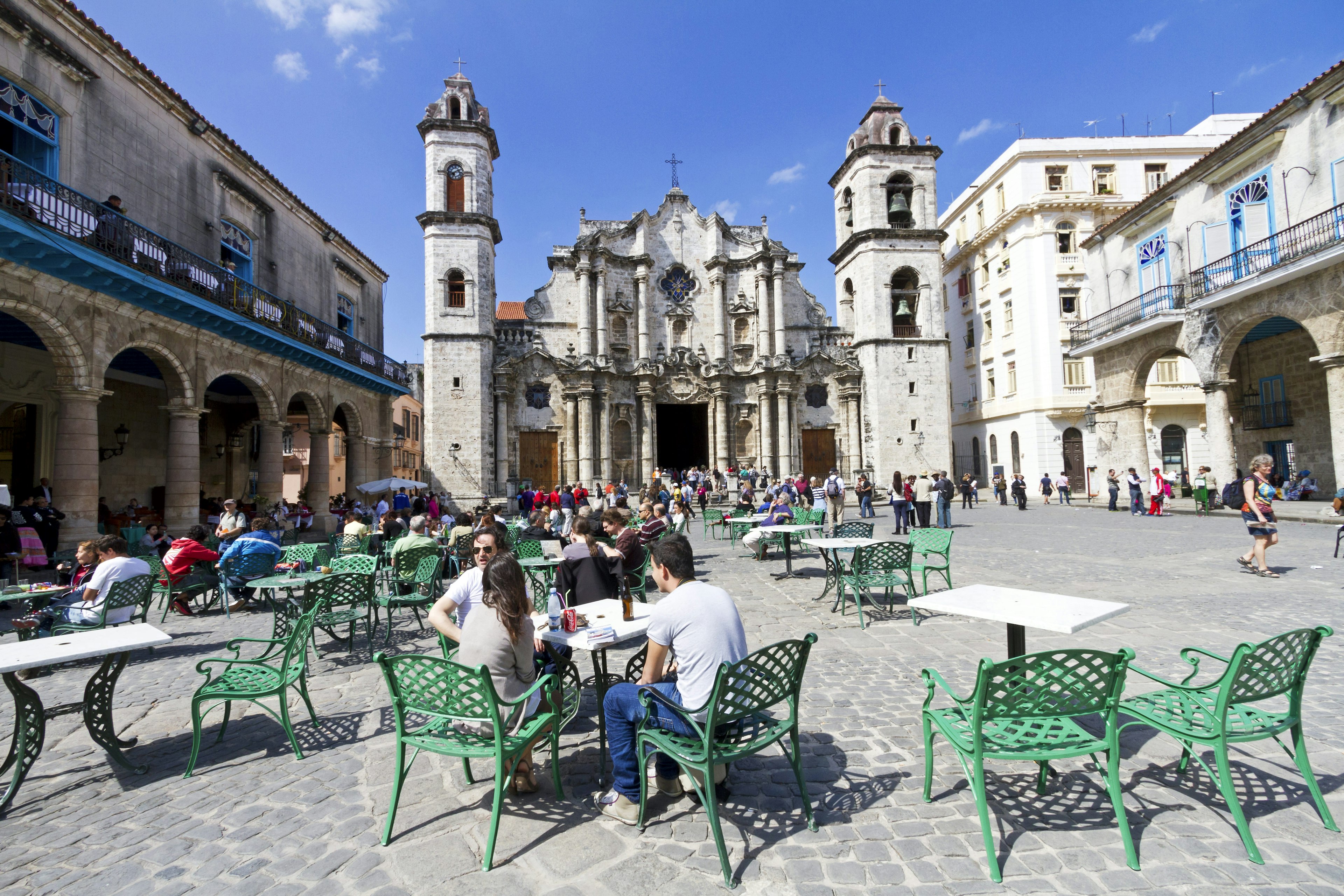 People sitting on outdoor cafe tables in the Plaza de la Catedra