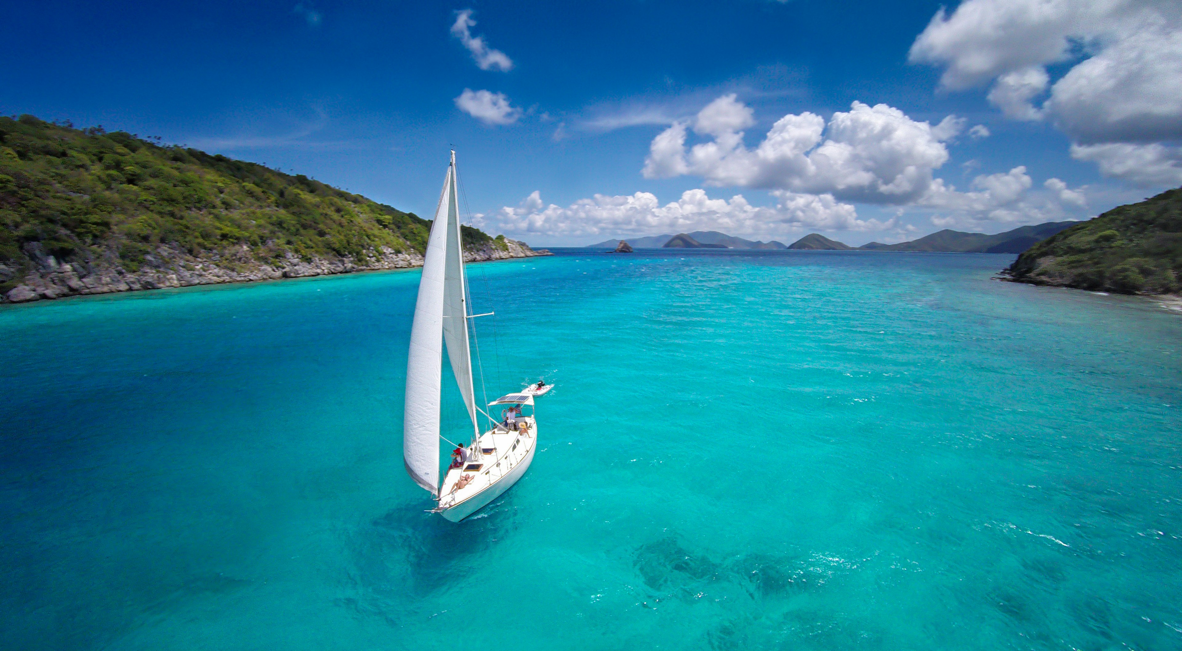 aerial view of a sloop sailing through the Caribbean