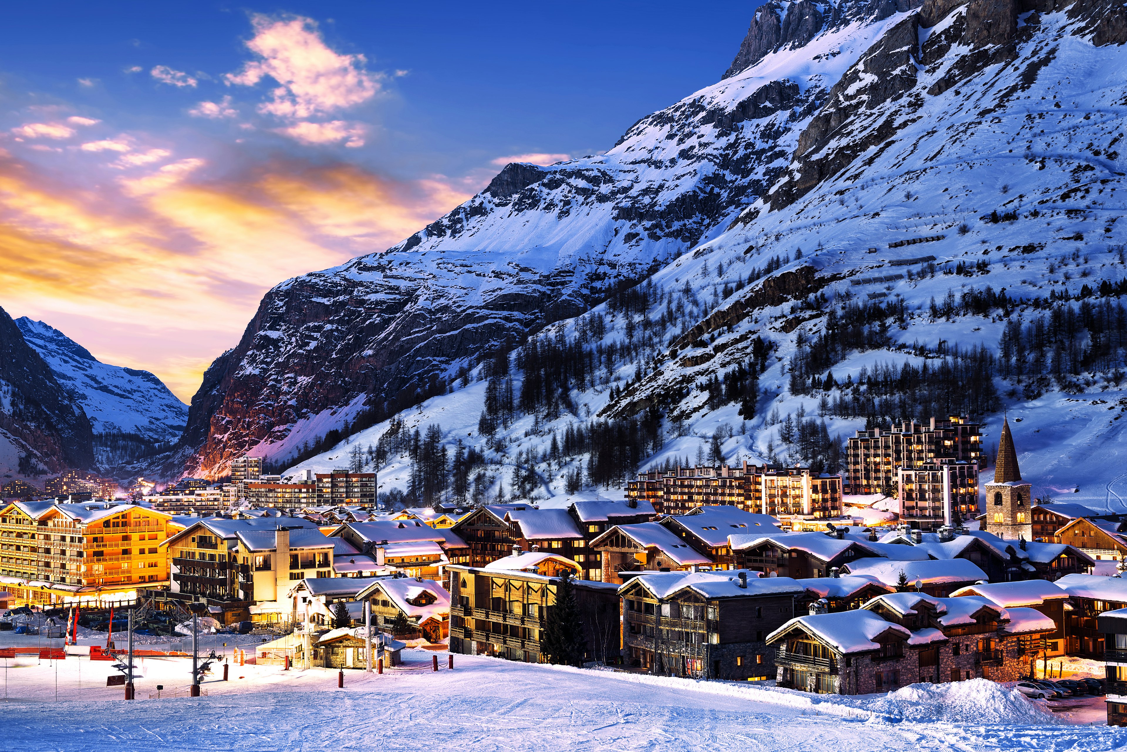 The town center of Val-d'Isere at dawn, with snow-covered roofs on ski lodges and chalets