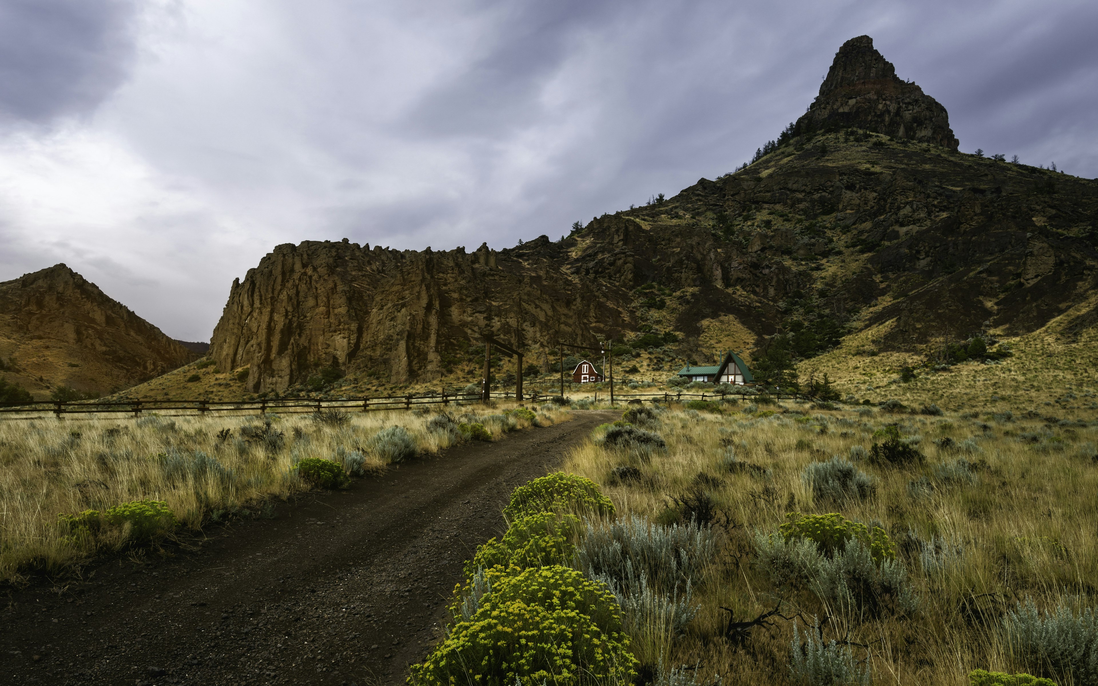 Homestead surrounded by rugged landscape, Cody, Wyoming, USA.
Horizontal Outdoors Rural Scene House Plant Fence USA Flower Cloud - Sky Summer Landscape Mountain Rock - Object Arid Climate Prairie Wyoming Cody - Wyoming Scenics Grass Overcast Dirt Road Natural Parkland Remote No People Photography Extreme Terrain Sagebrush Buffalo Bill Cody 2015 Buffalo Bill State Park