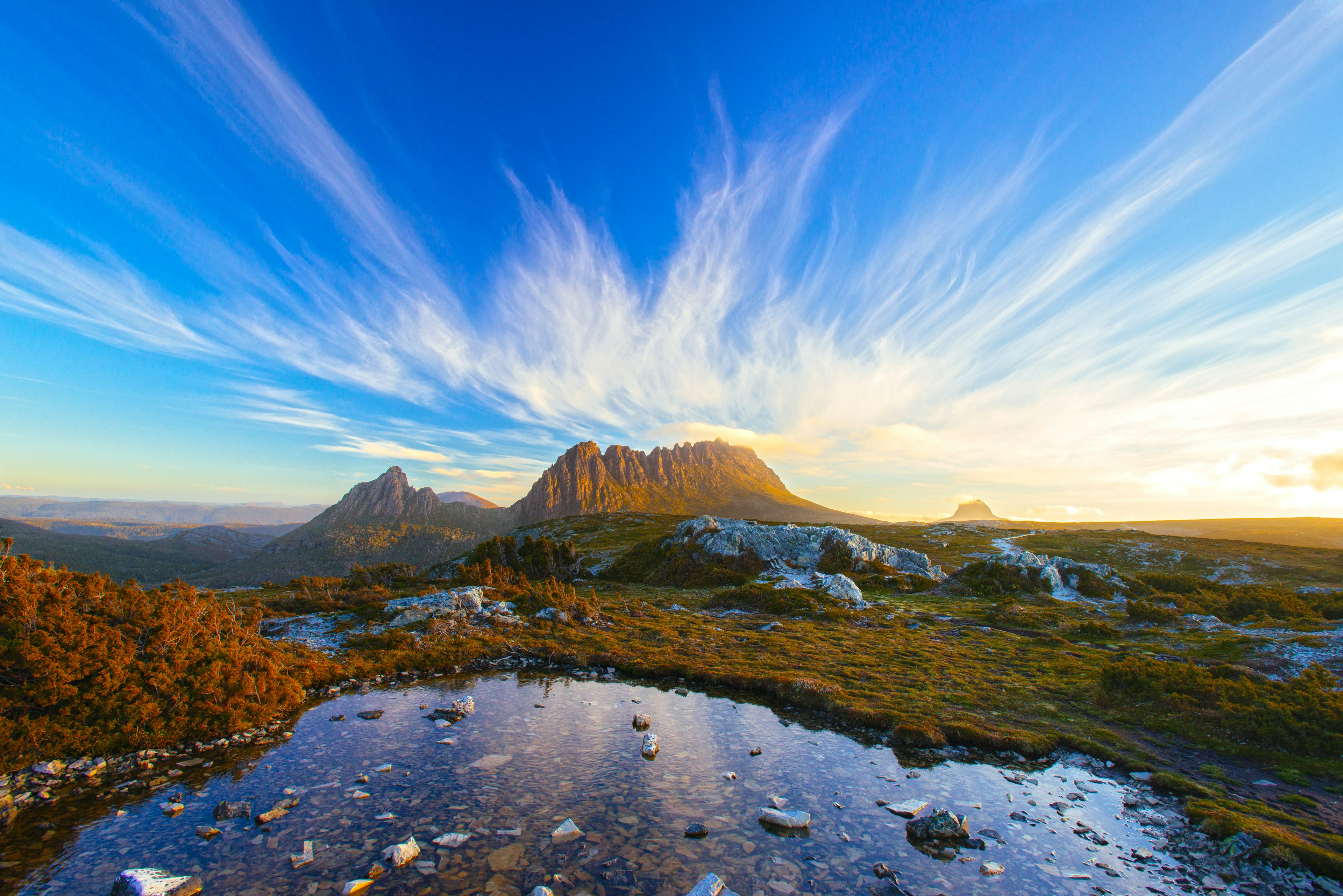 A mountain in the distance glows with setting sun.