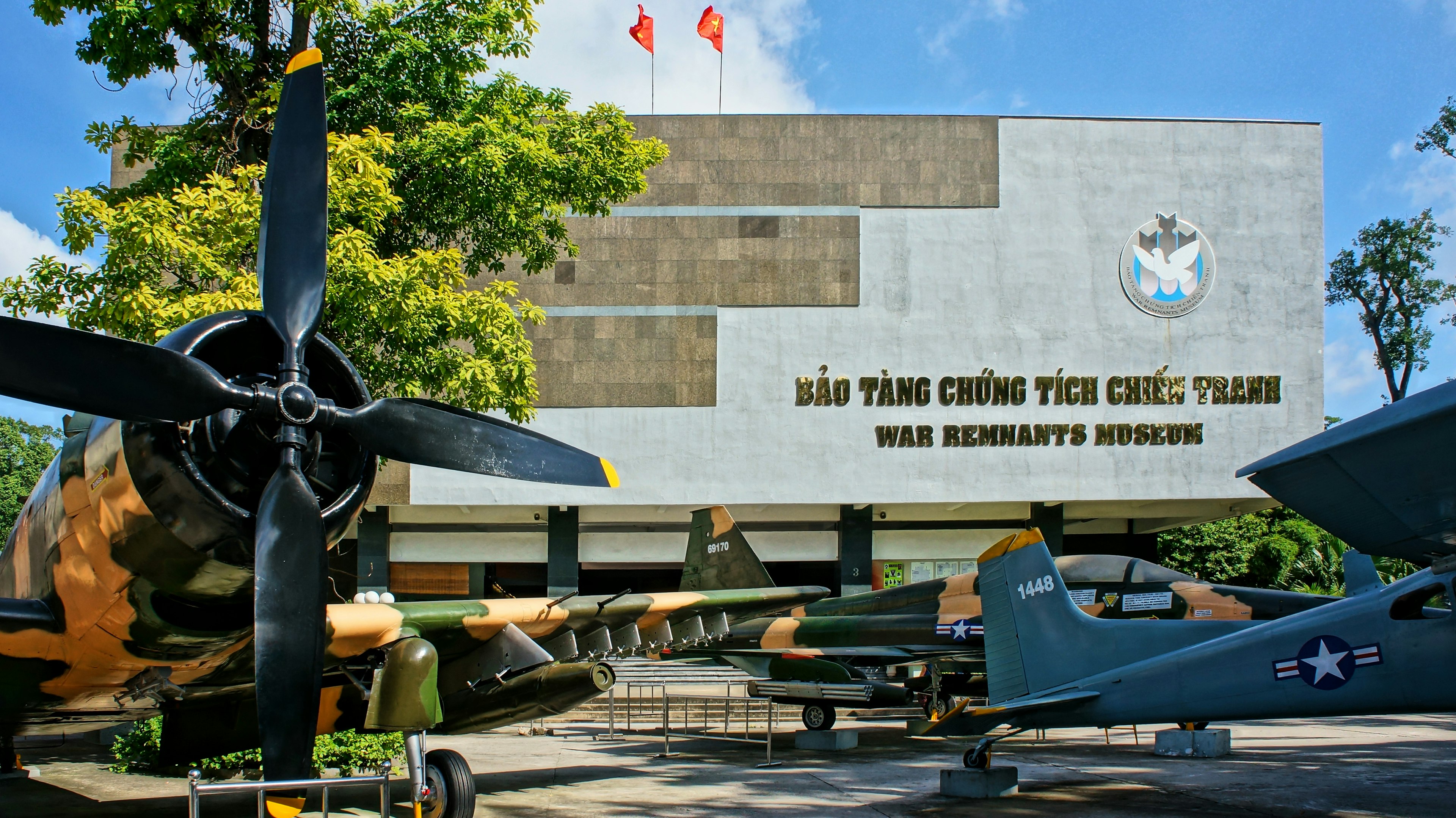 Exterior of a museum with three planes on display