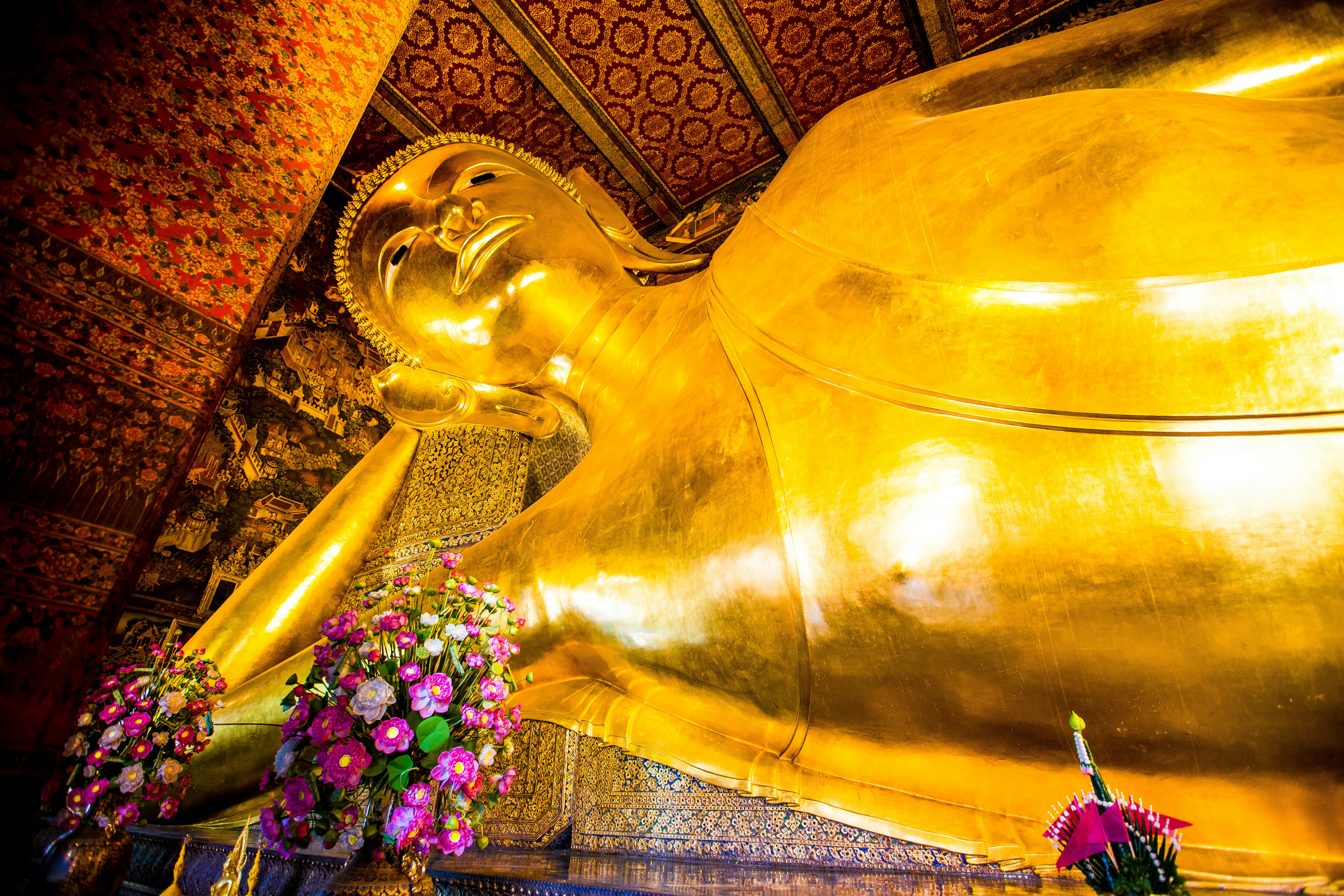 The golden, giant reclining Buddha statue lays on its side at Wat Pho temple in Bangkok, Thailand.