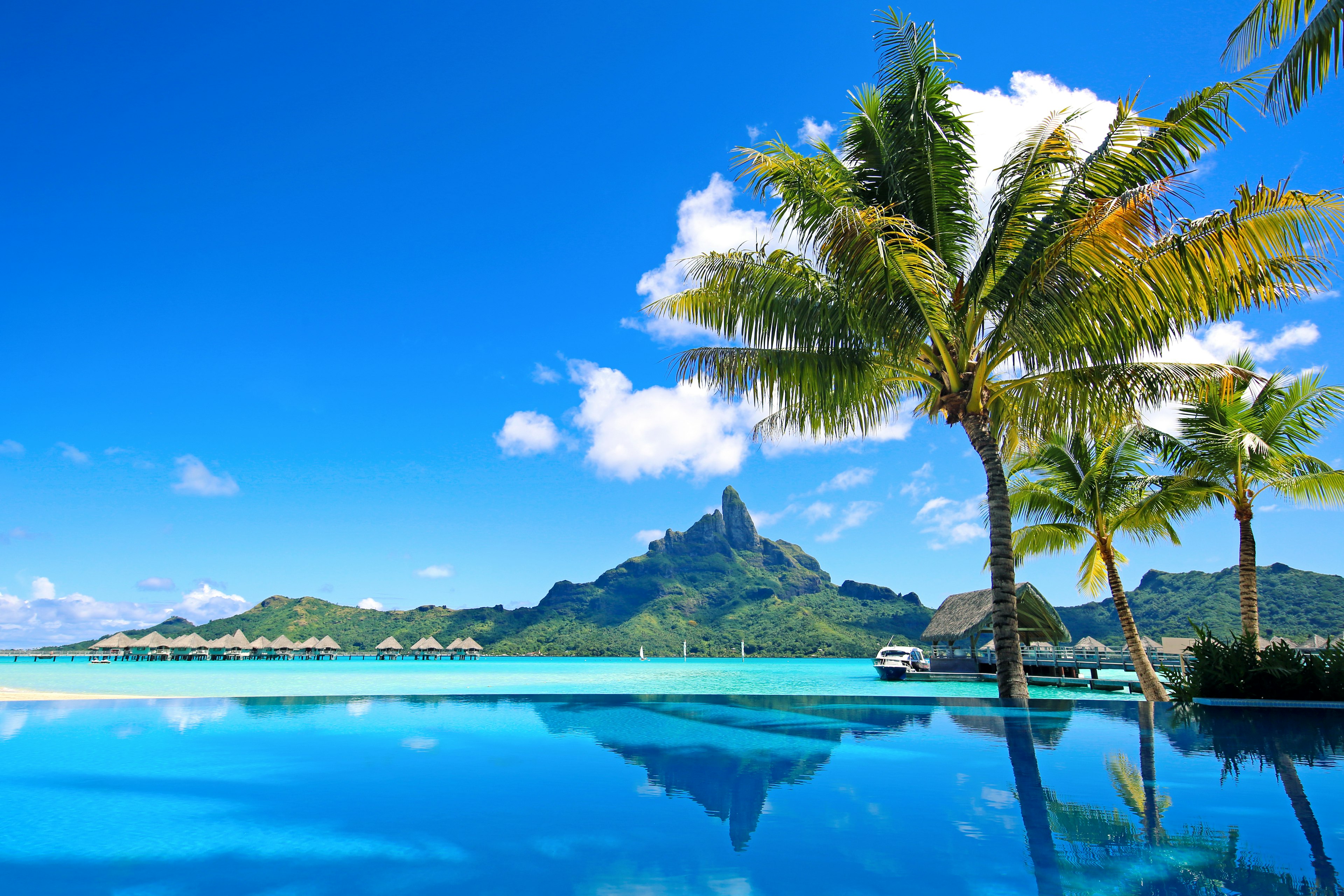 Mt Otemanu reflected in a hotel infinity pool