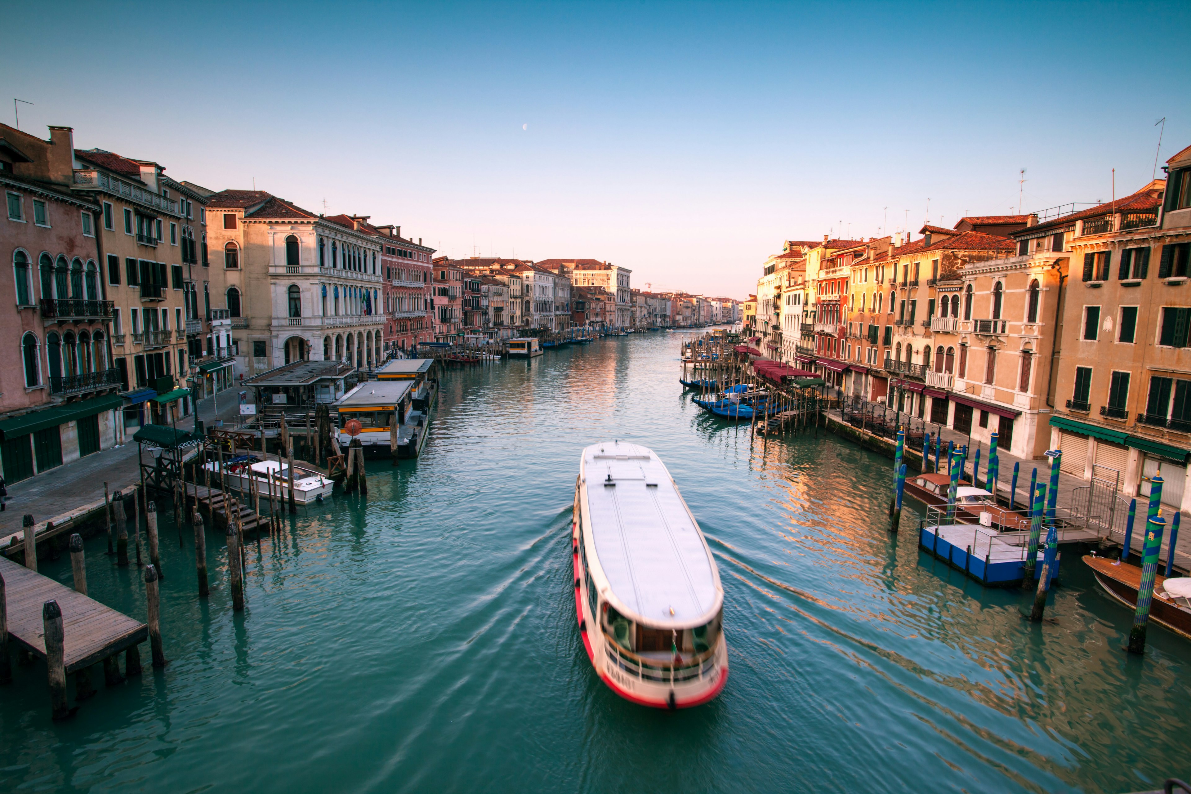 Vaporetto passing along the Grand Canal, Venice, Italy as seen from Rialto bridge, at sunrise.