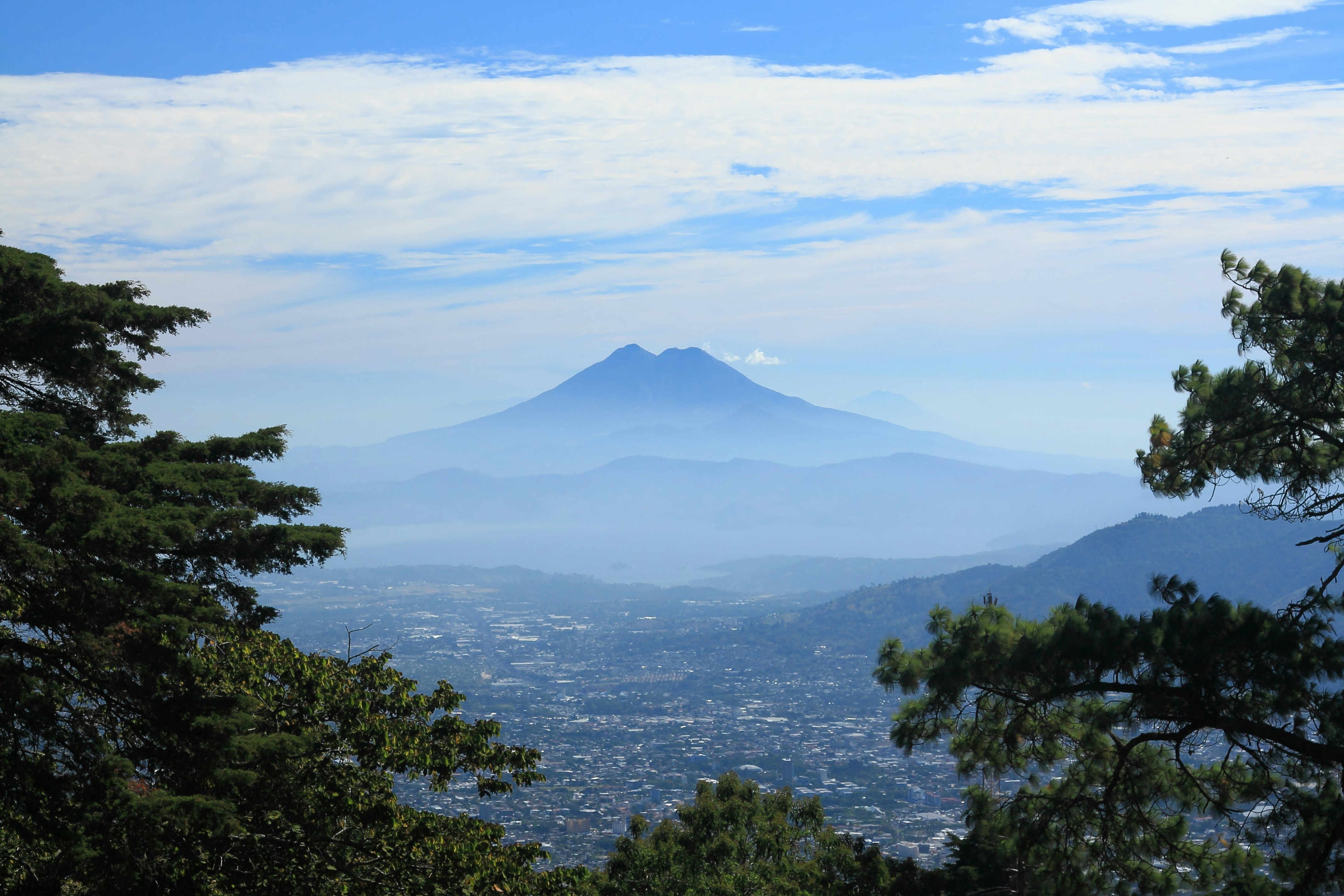A misty valley in the foothills of a volcano.