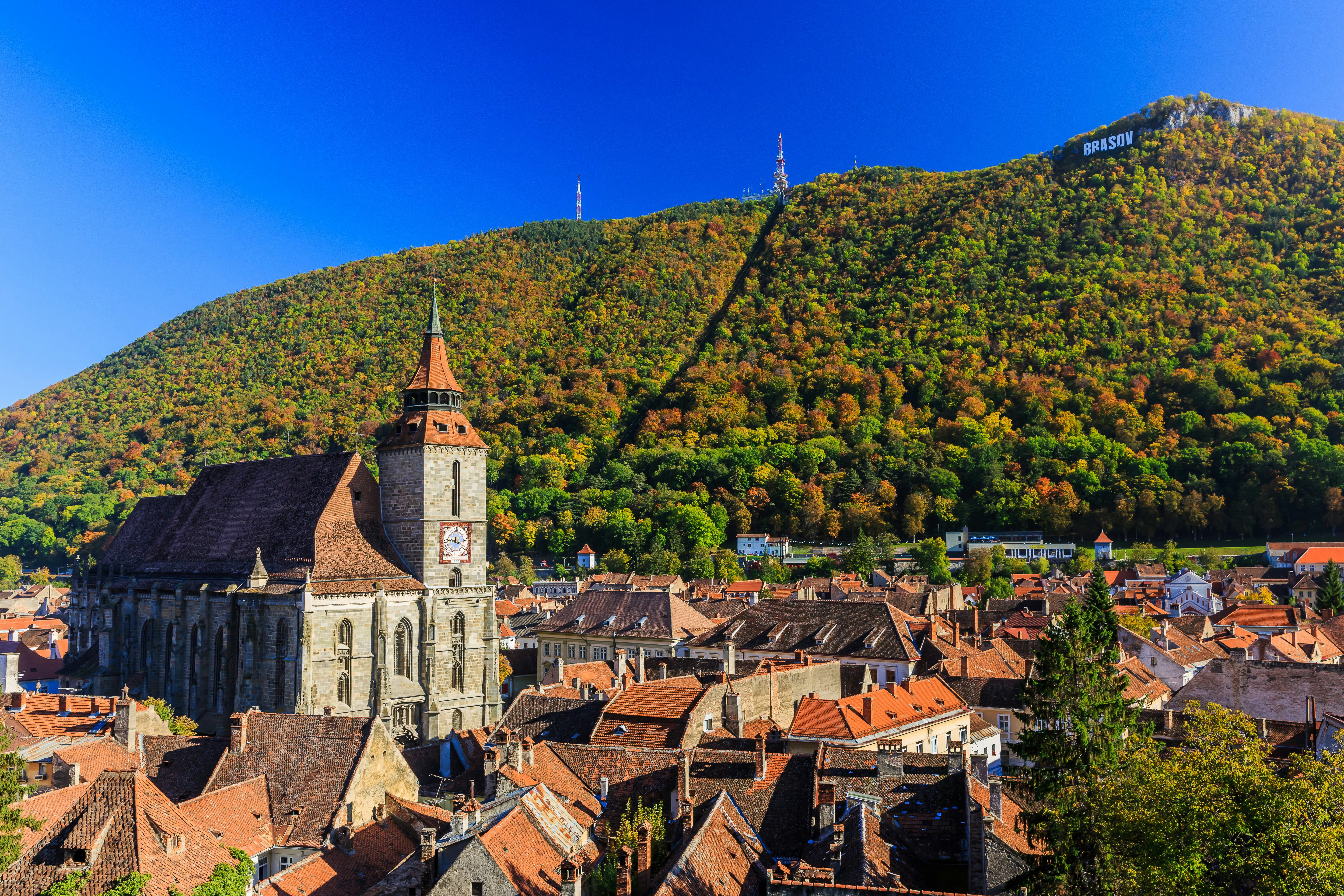 Brasov and its most important landmark, the Black Church towers over the old town. Transylvania, Romania.