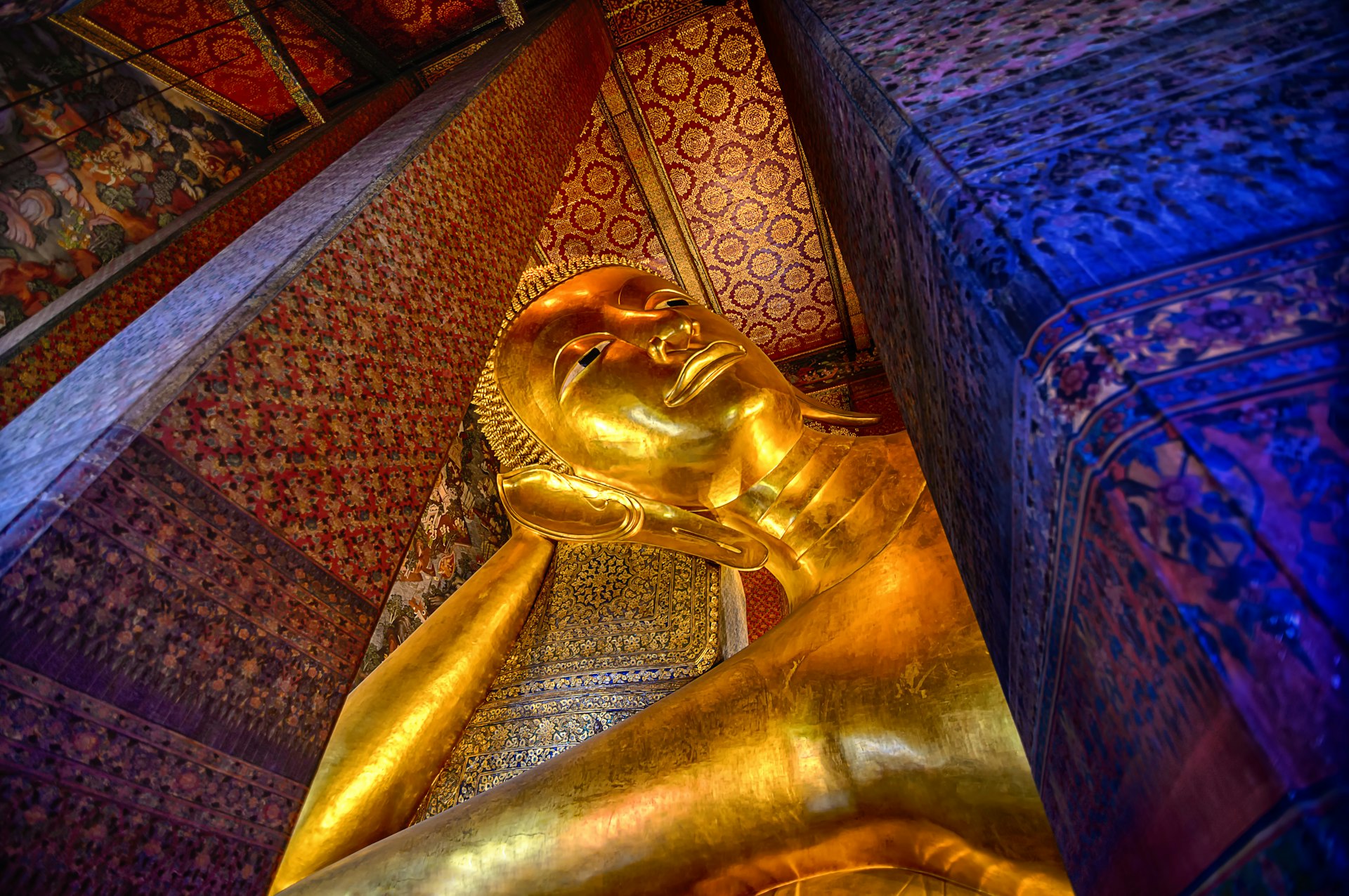 The Reclining Buddha inside the Wat Phra Chetuphon Vimolmangklararm Rajwaramahaviharn in a Buddhist temple complex of Wat Pho in the Phra Nakhon District, Bangkok, 