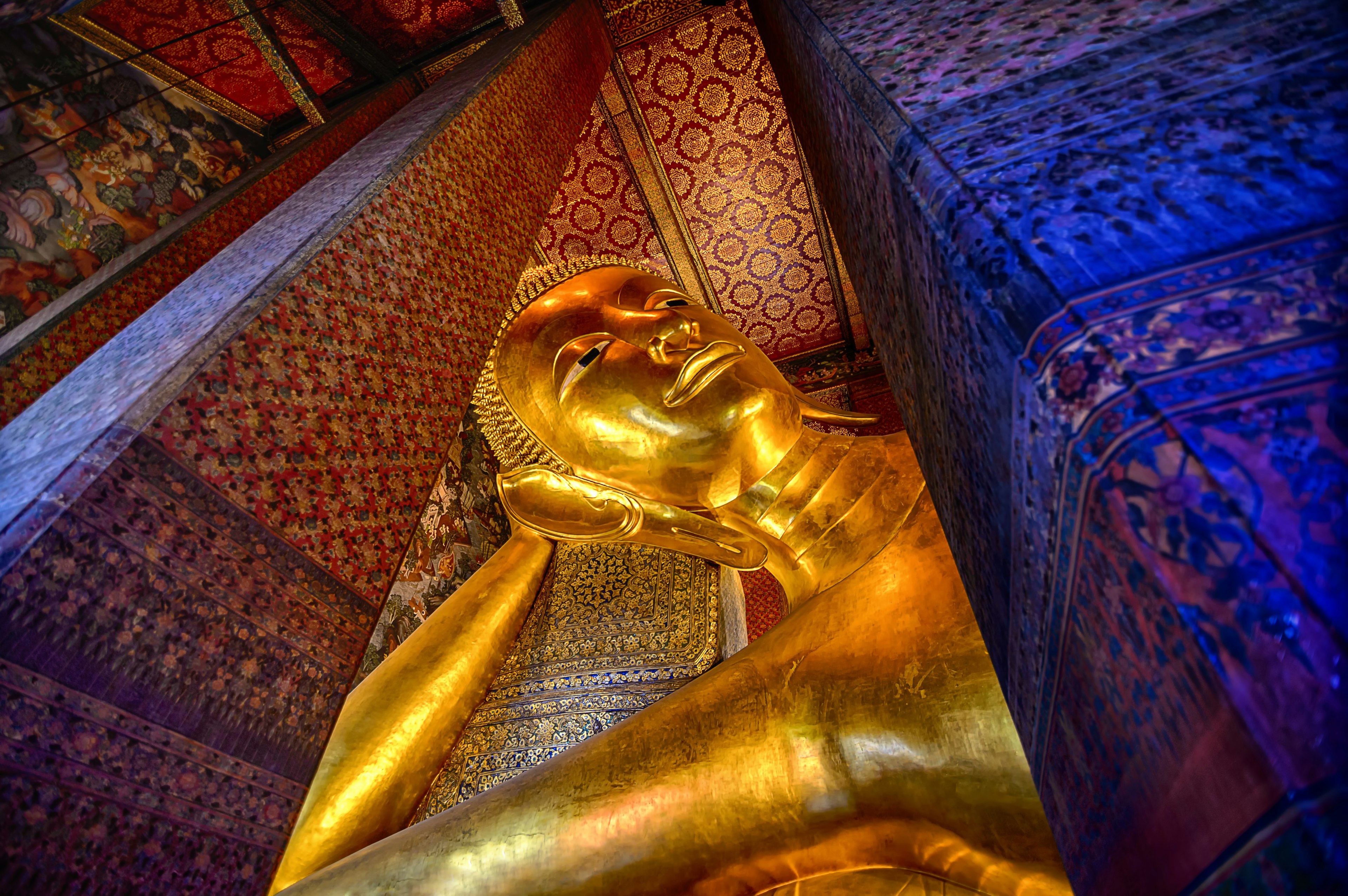 The Reclining Buddha inside the Wat Phra Chetuphon Vimolmangklararm Rajwaramahaviharn in a Buddhist temple complex of Wat Pho in the Phra Nakhon District, Bangkok,