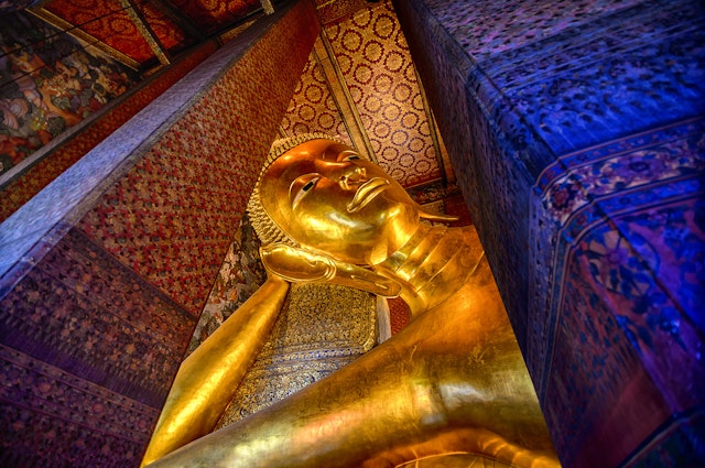 The Reclining Buddha inside the Wat Phra Chetuphon Vimolmangklararm Rajwaramahaviharn in a Buddhist temple complex of Wat Pho in the Phra Nakhon District, Bangkok,