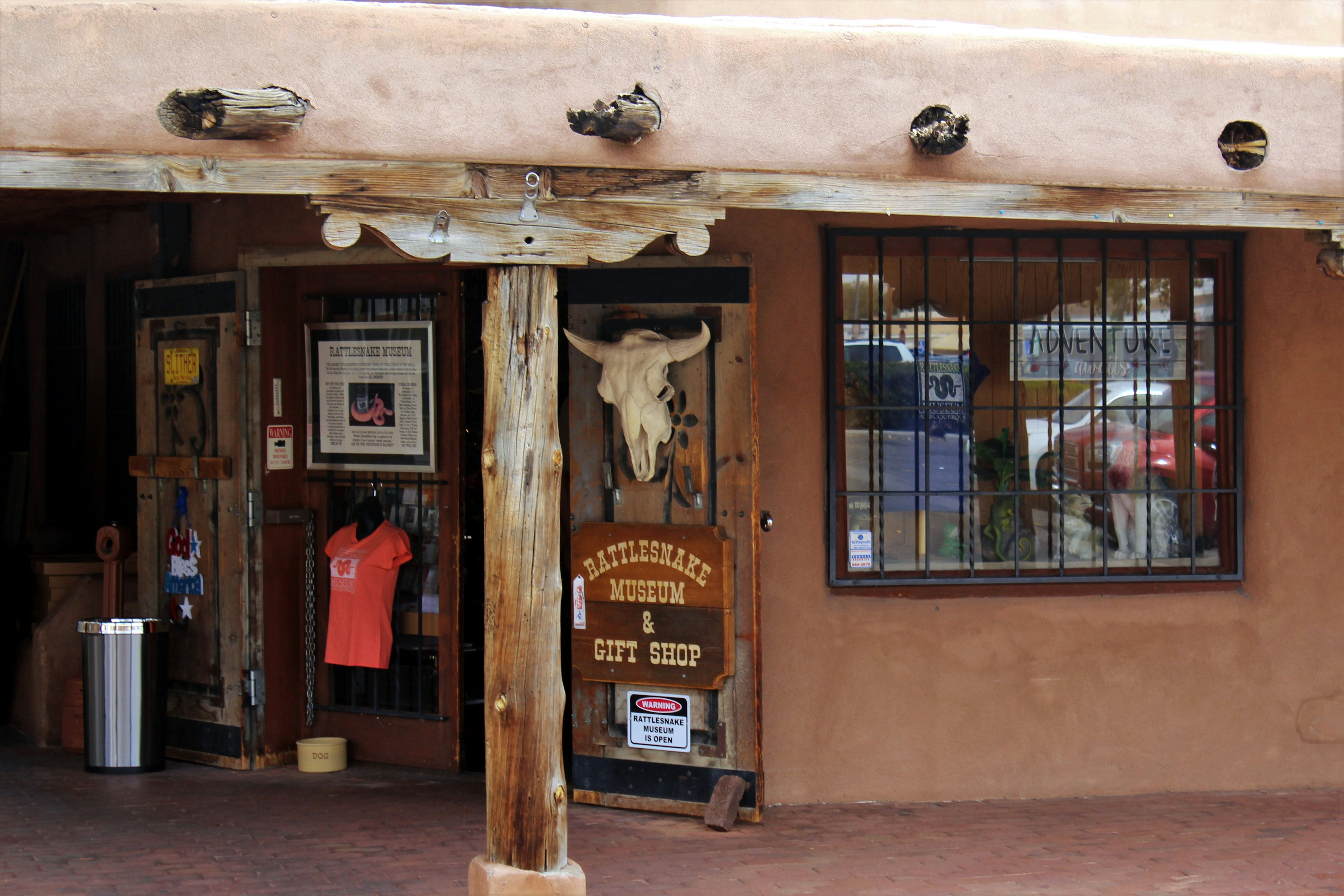 Exterior of American International Rattlesnake Museum with various paraphernalia