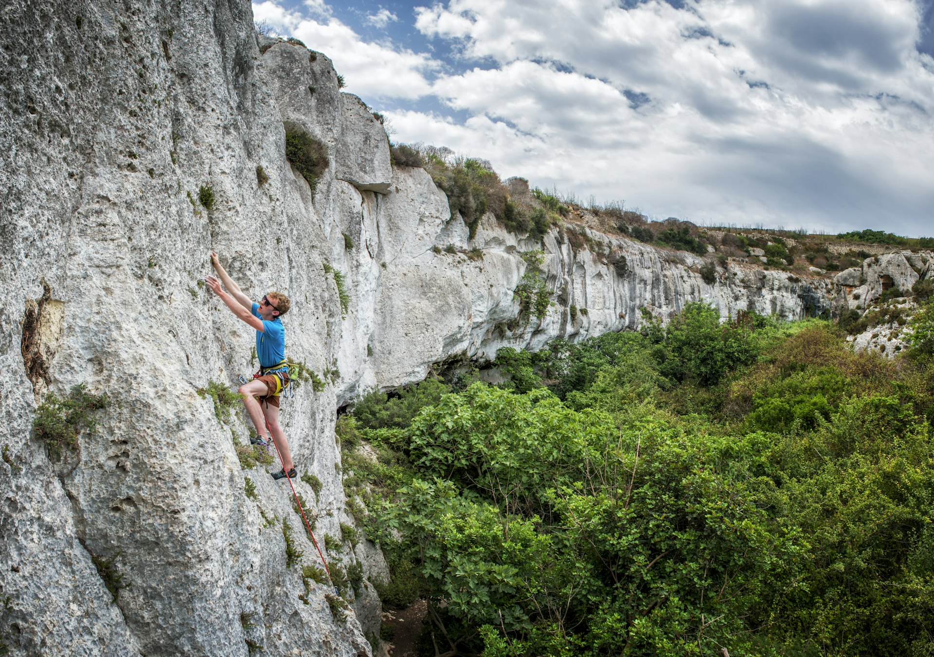 A rock climber scales the cliffs at Mgarr IX Xini in Gozo.