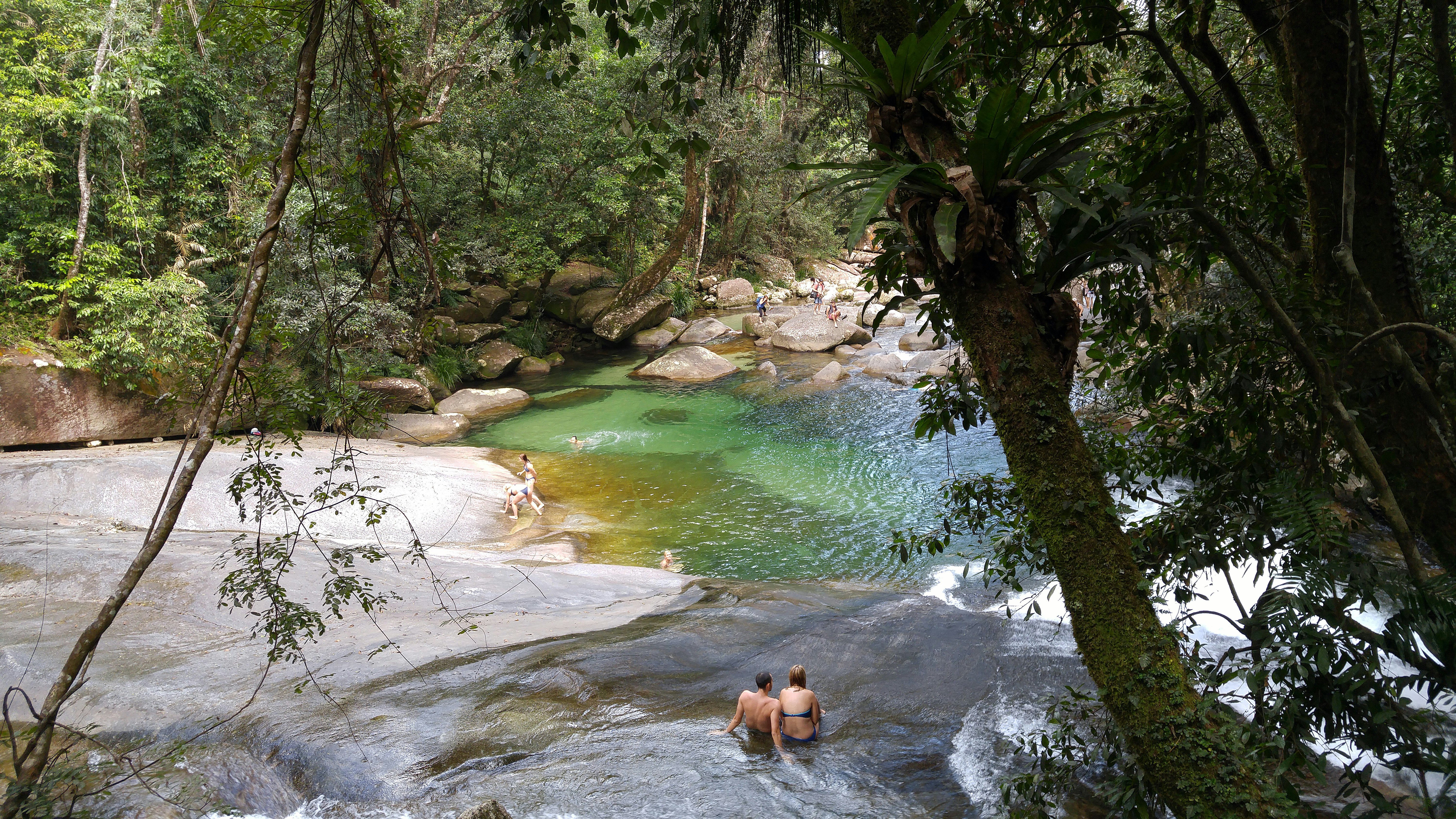 People bathing at Josephine Falls, a tiered cascade waterfall on Josephine Creek located in the Far North region of Queensland