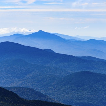 Vermont mountain range, as seen from the top of Mount Mansfield near Stowe.
611611384
Travel, Cloud - Sky, No People, Famous Place, Horizon, Mt Mansfield, Blue, Woodland, North America, Tranquil Scene, Eco Tourism, Forest, Tree, Stowe - Vermont, Travel Destinations, Horizontal, Mountain, Landscape - Scenery, Scenics - Nature, Mountain Range, Rolling Landscape, Outdoors, New England - USA, Color Image, Rural Scene, Green Mountain National Forest, Horizon Over Land, Mountain Peak, Beauty In Nature, Idyllic, Vermont, Wood - Material, Photography, Wilderness Area, Photograph, Nature, Landscape