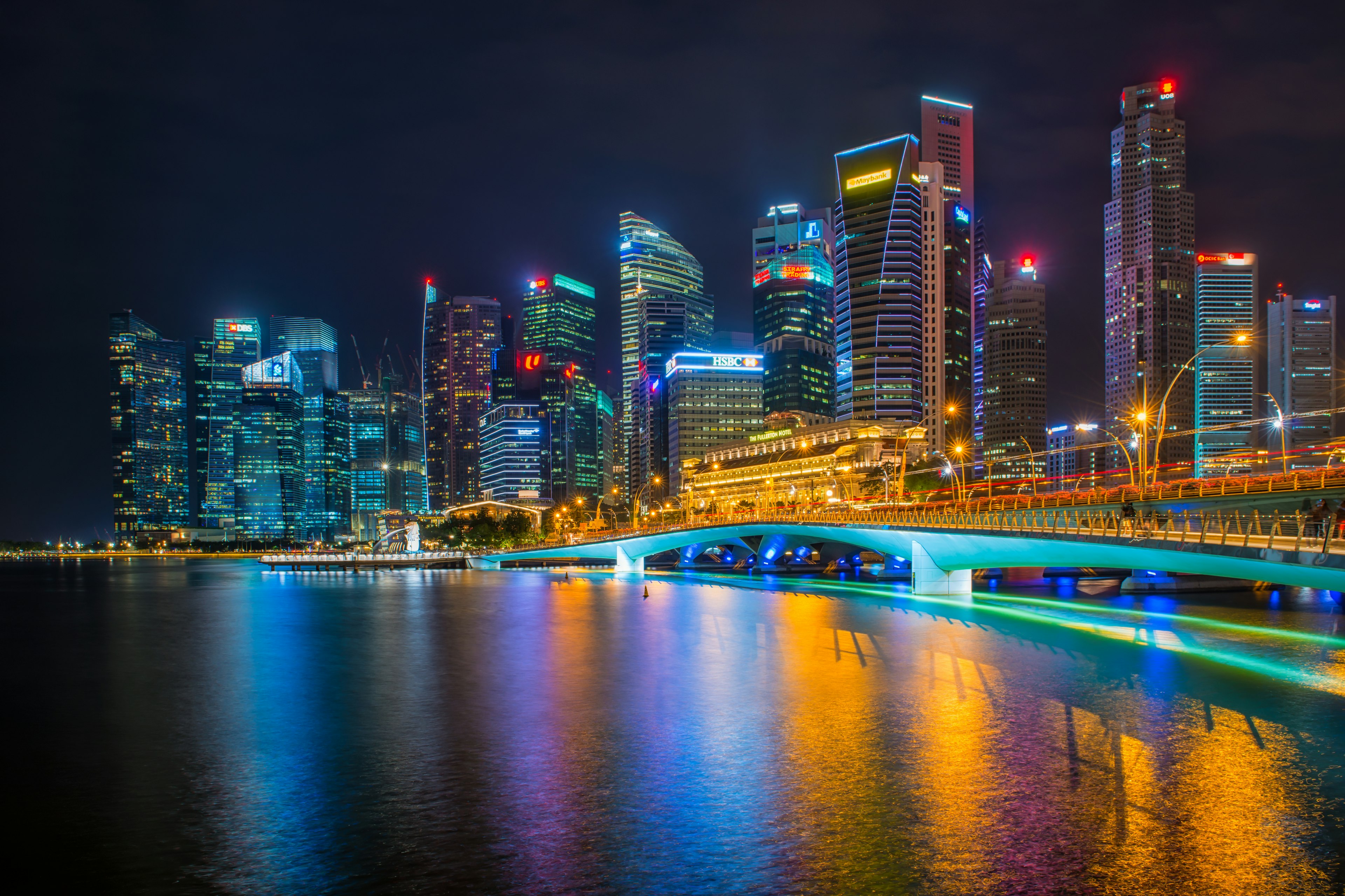 Commercial skyscrapers in Marina Bay and Merlion Park at night time of Singapore.